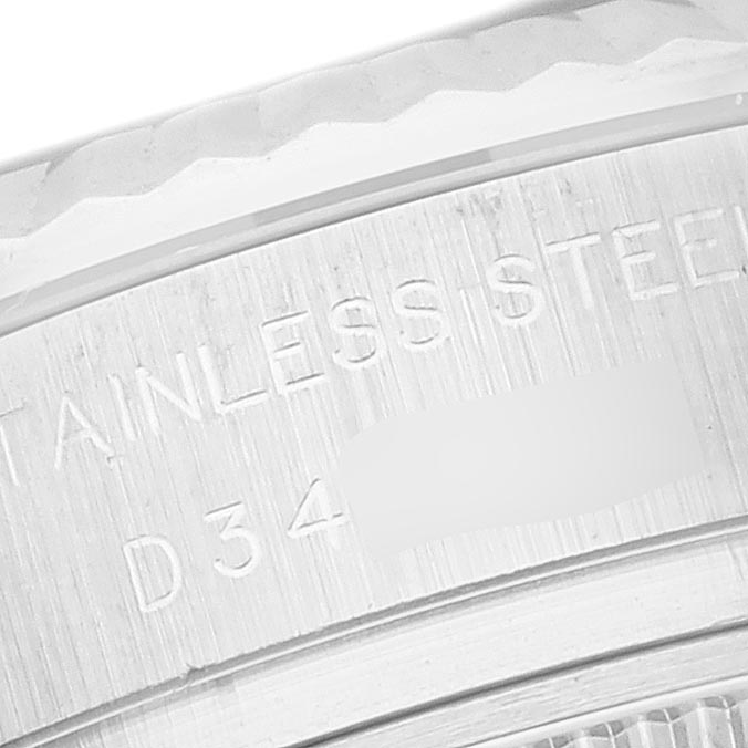 The image shows a close-up of the Rolex Datejust 179174 Women
s Stainless Steel Mother of Pearl Dial 179174 Women
s Stainless Steel Mother of Pearl Dial watch, focusing on the stainless steel detail and serial engraving on the case back.