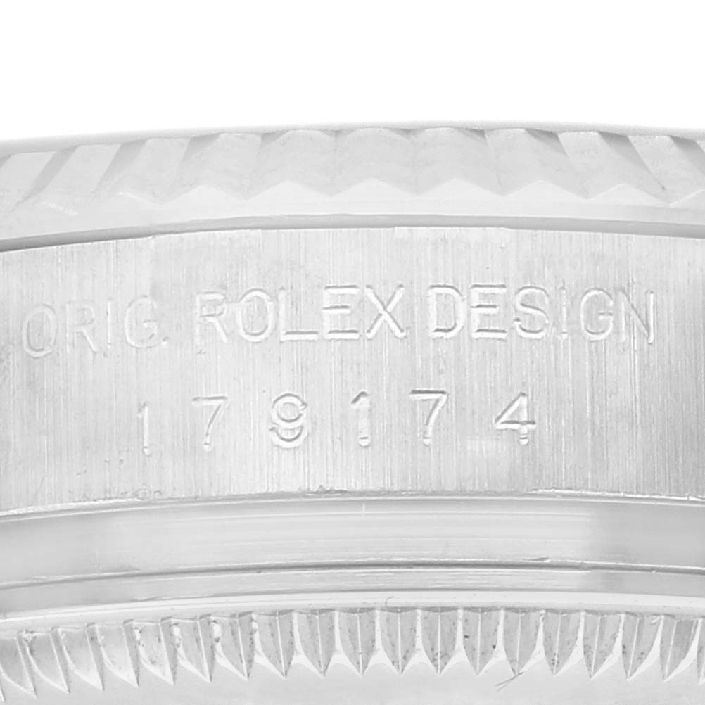 The image shows an angled close-up of the Rolex Datejust 179174 Women
s Stainless Steel Mother of Pearl Dial 179174 Women
s Stainless Steel Mother of Pearl Dial model
s case edge, highlighting the model number and design engraving.