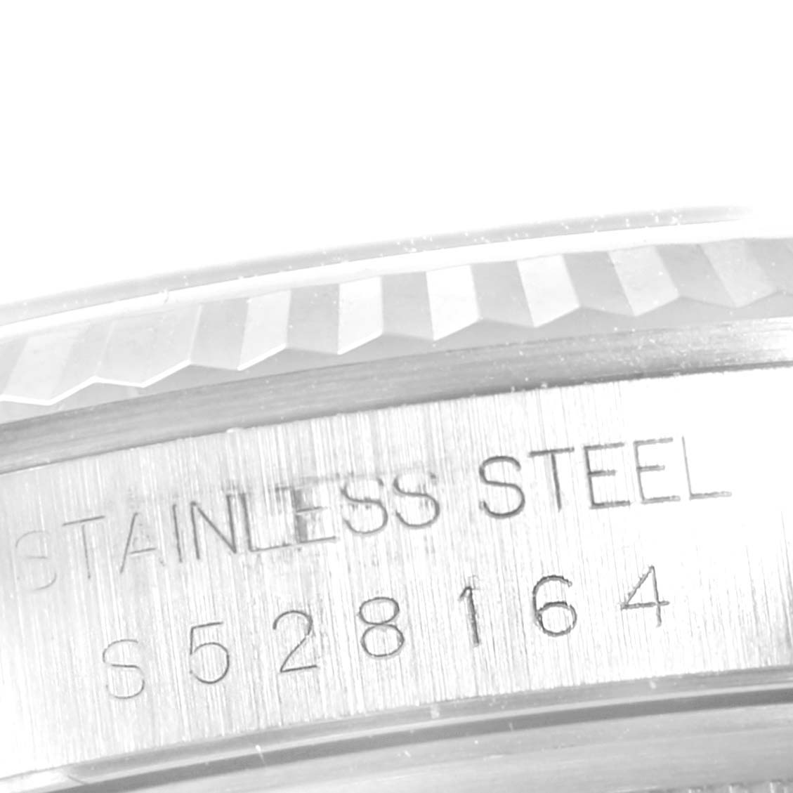 This close-up image shows the side of a Rolex Datejust 16234 Men's Stainless Steel Silver Dial 16234 Men's Stainless Steel Silver Dial watch, highlighting its stainless steel casing and serial number.