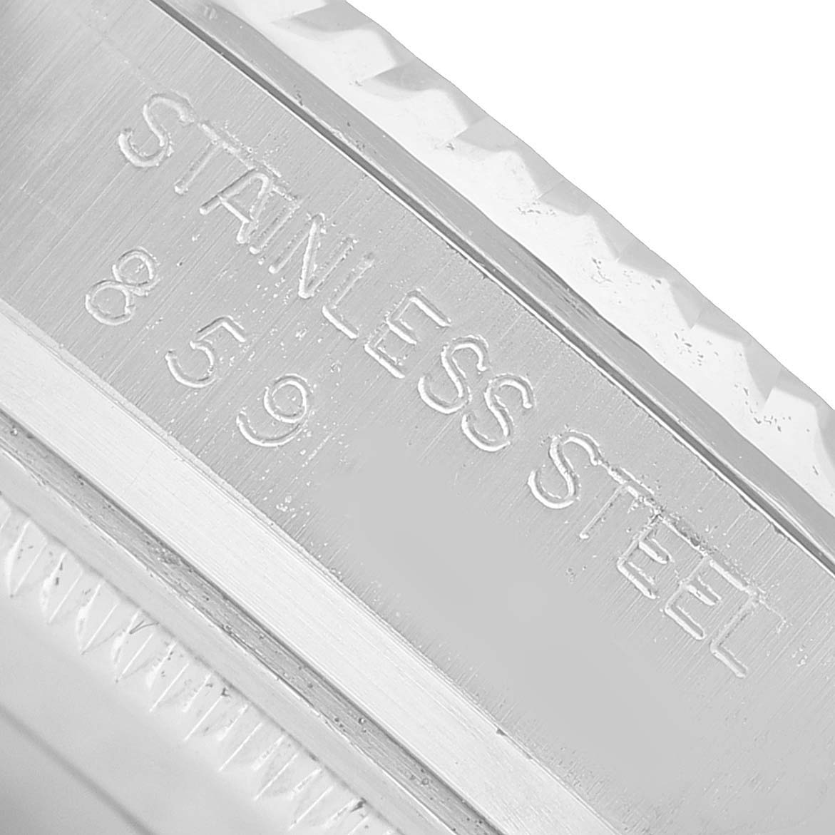 The image shows a close-up of the side of a Rolex Datejust 16014 Men's Stainless Steel Silver Dial's stainless steel case with engraved text.