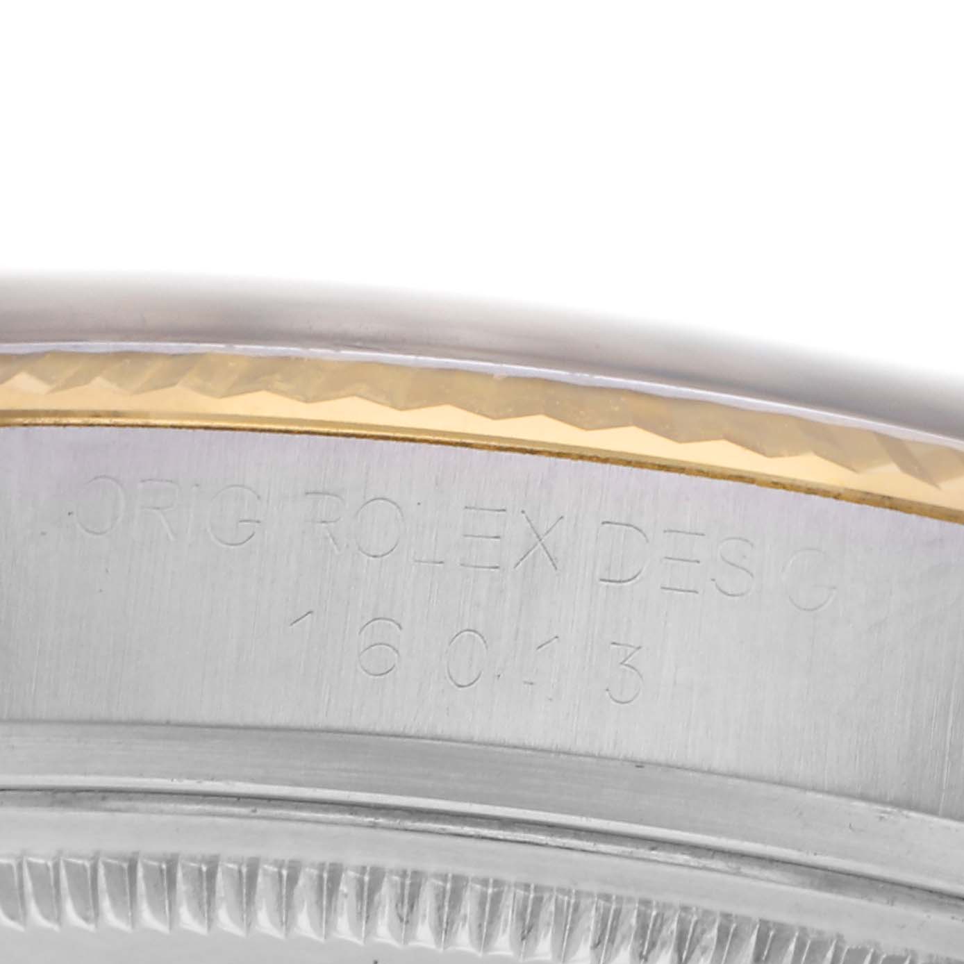 The image shows a close-up of a Rolex Datejust 16013 Men
s Steel and Gold (two tone) Black Dial 16013 Men
s Steel and Gold (two tone) Black Dial model with visible engravings on the case edge.