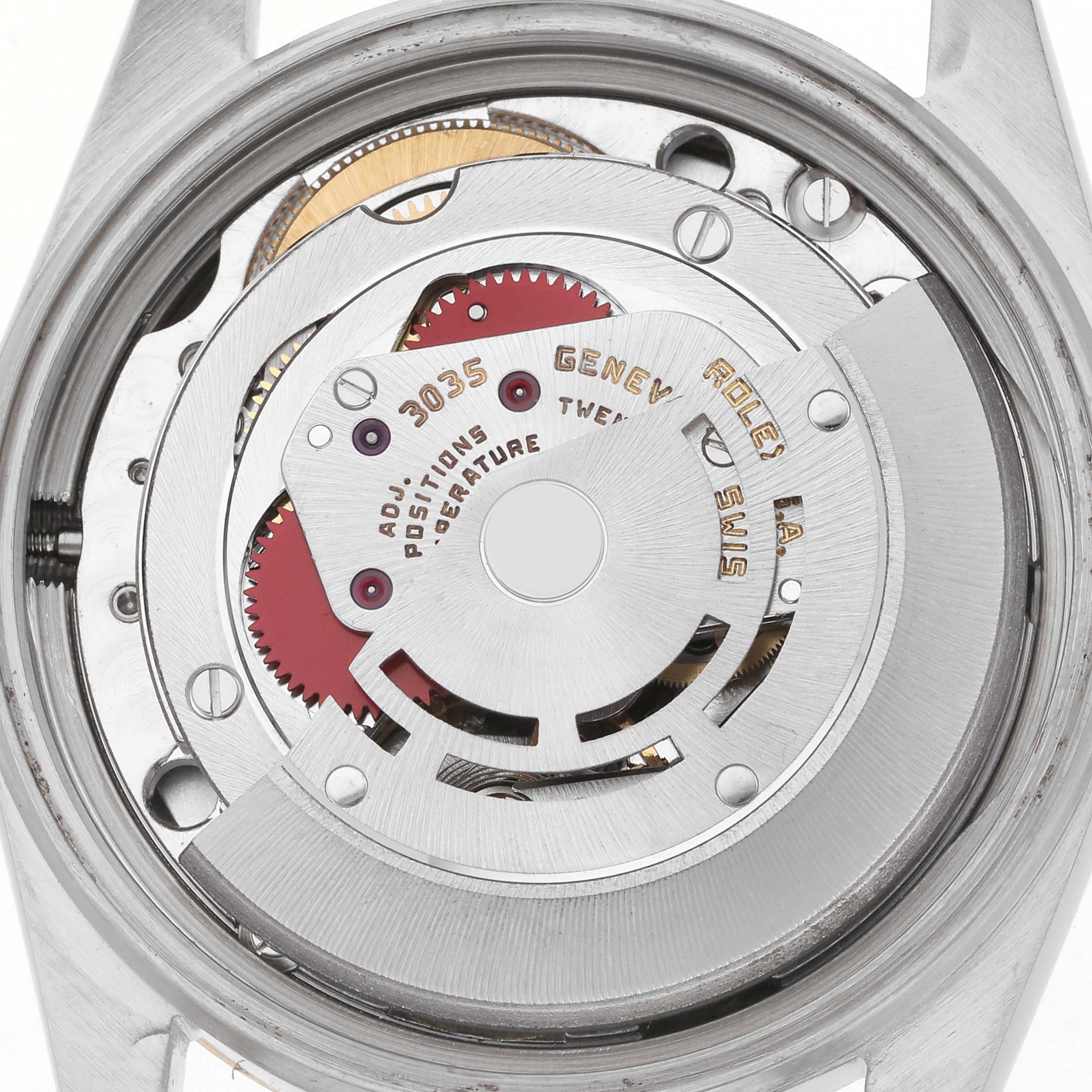 The image shows the Rolex Datejust 16013 Men
s Steel and Gold (two tone) Black Dial 16013 Men
s Steel and Gold (two tone) Black Dial
s movement from a top-down angle, highlighting its intricate internal mechanics.