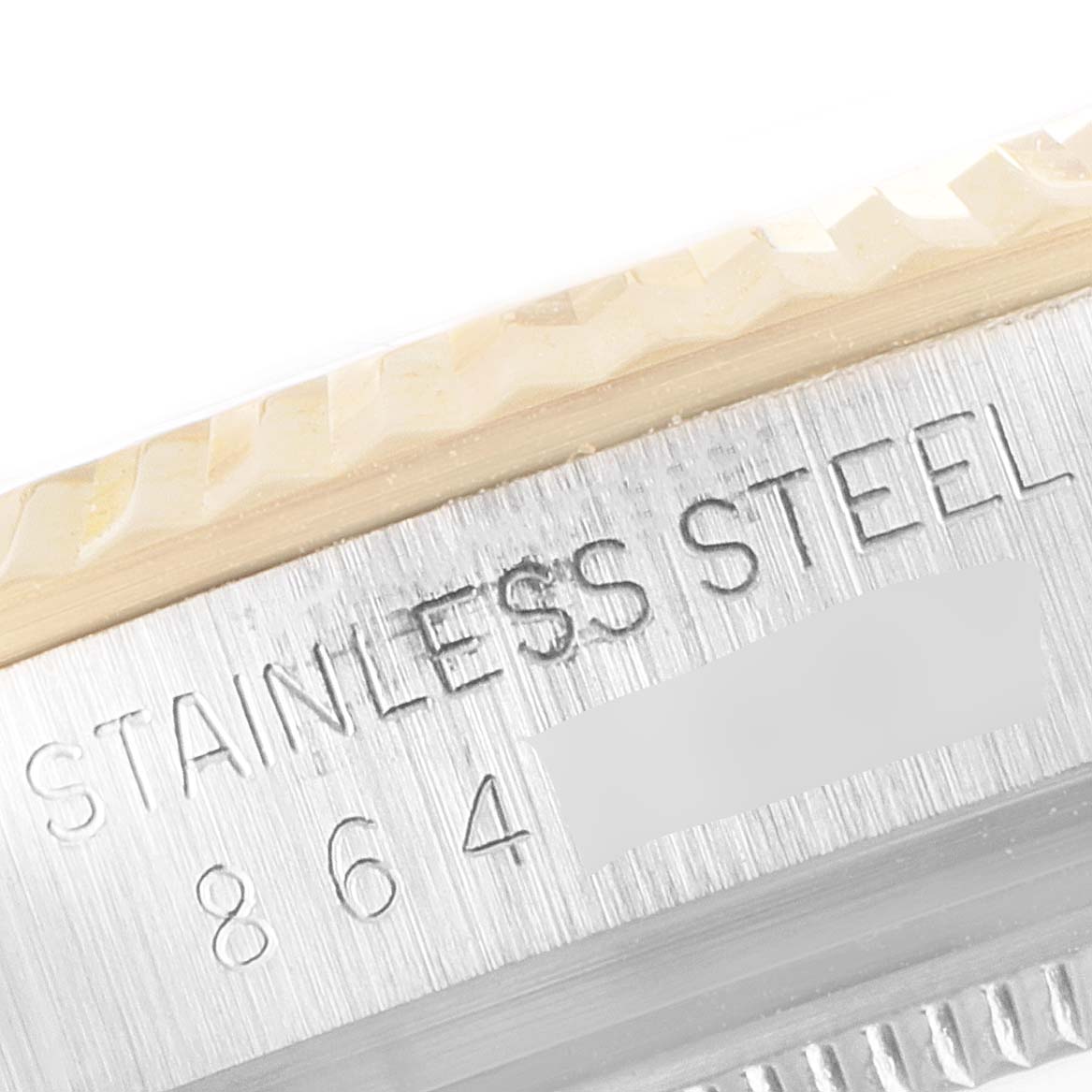 The image shows a close-up of the stainless steel casing with engravings for a Vintage Collection Rolex watch.