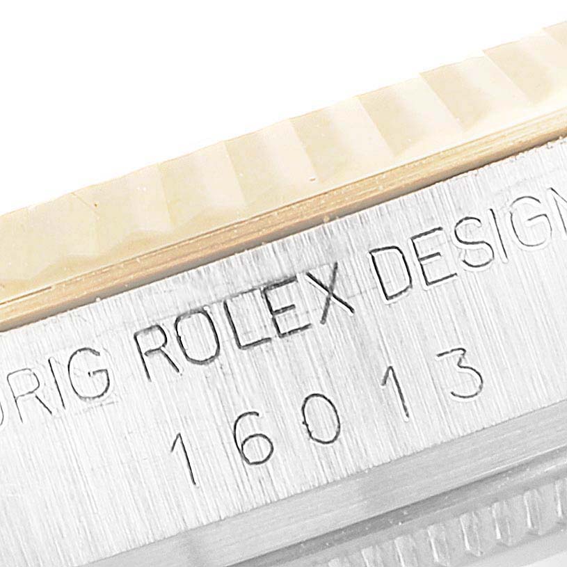 The image shows a close-up of the engraved bezel and case side of a Vintage Collection Rolex model 16013.