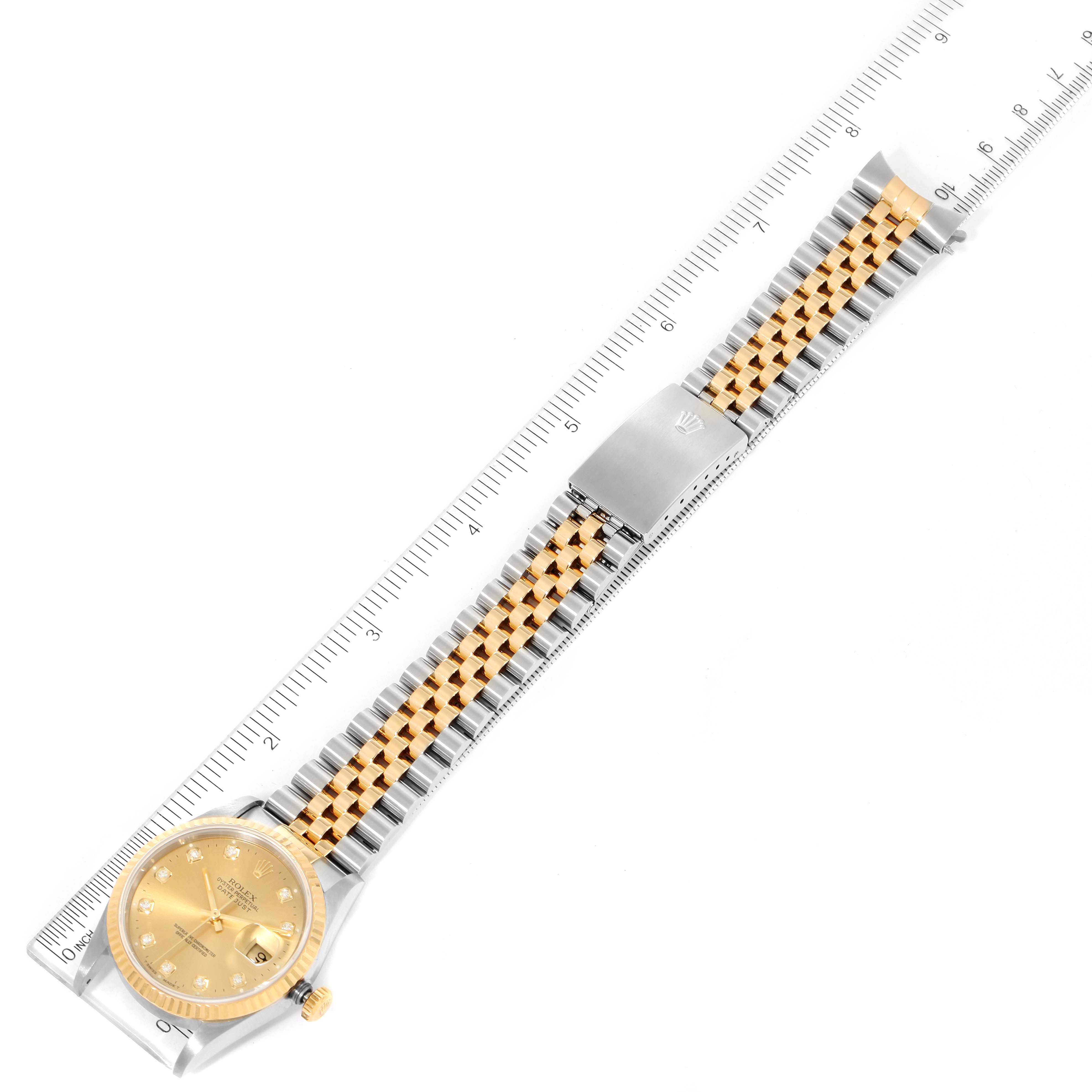 The image shows a top-down view of a Rolex Datejust 16233 Men's Steel and Gold (two tone) Champagne Dial 16233 Men's Steel and Gold (two tone) Champagne Dial watch, displaying the dial, bracelet, and clasp against a ruler.