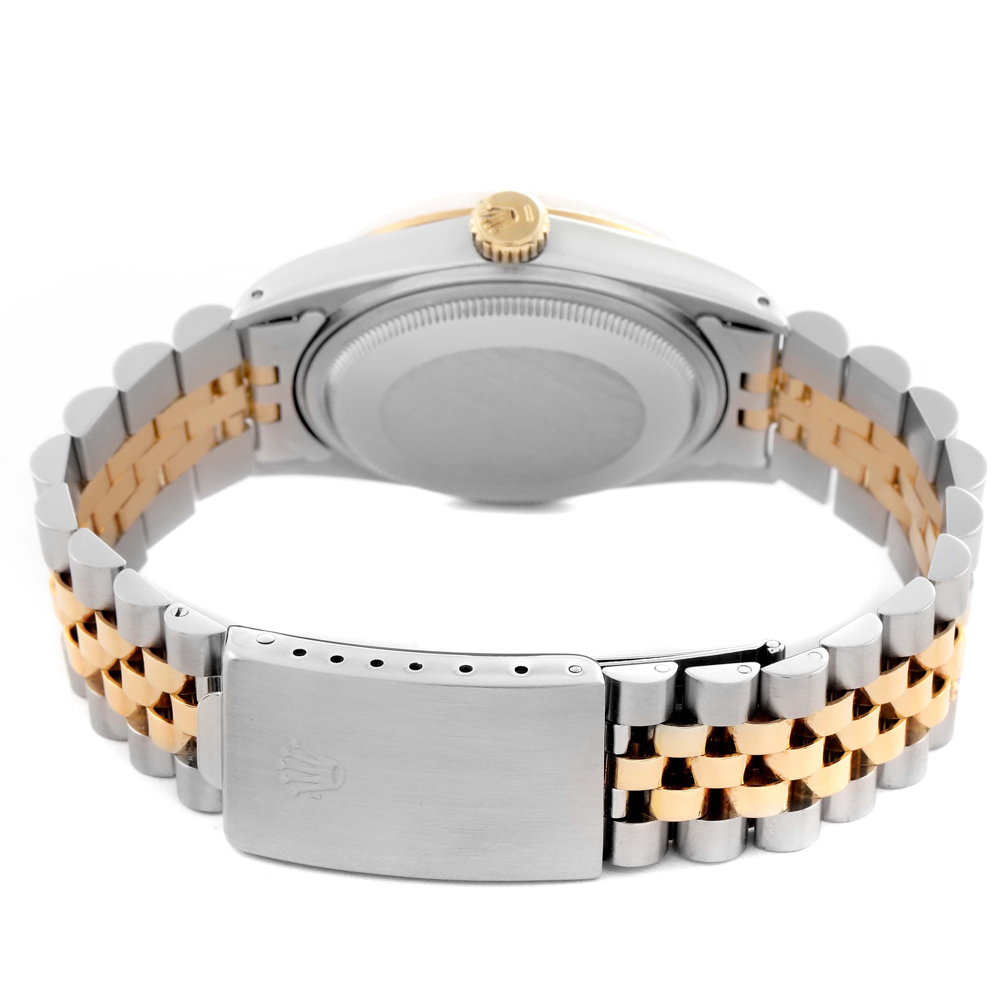 The image shows the back of the Rolex Datejust 16013 Men
s Steel and Gold (two tone) Champagne Dial 16013 Men
s Steel and Gold (two tone) Champagne Dial watch, focusing on the case back, crown, and two-tone bracelet clasp.