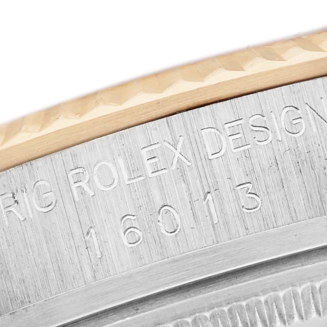 The image shows a close-up of the engraved side case bezel edge of a Rolex Datejust 16013 Men
s Steel and Gold (two tone) Champagne Dial 16013 Men
s Steel and Gold (two tone) Champagne Dial watch.