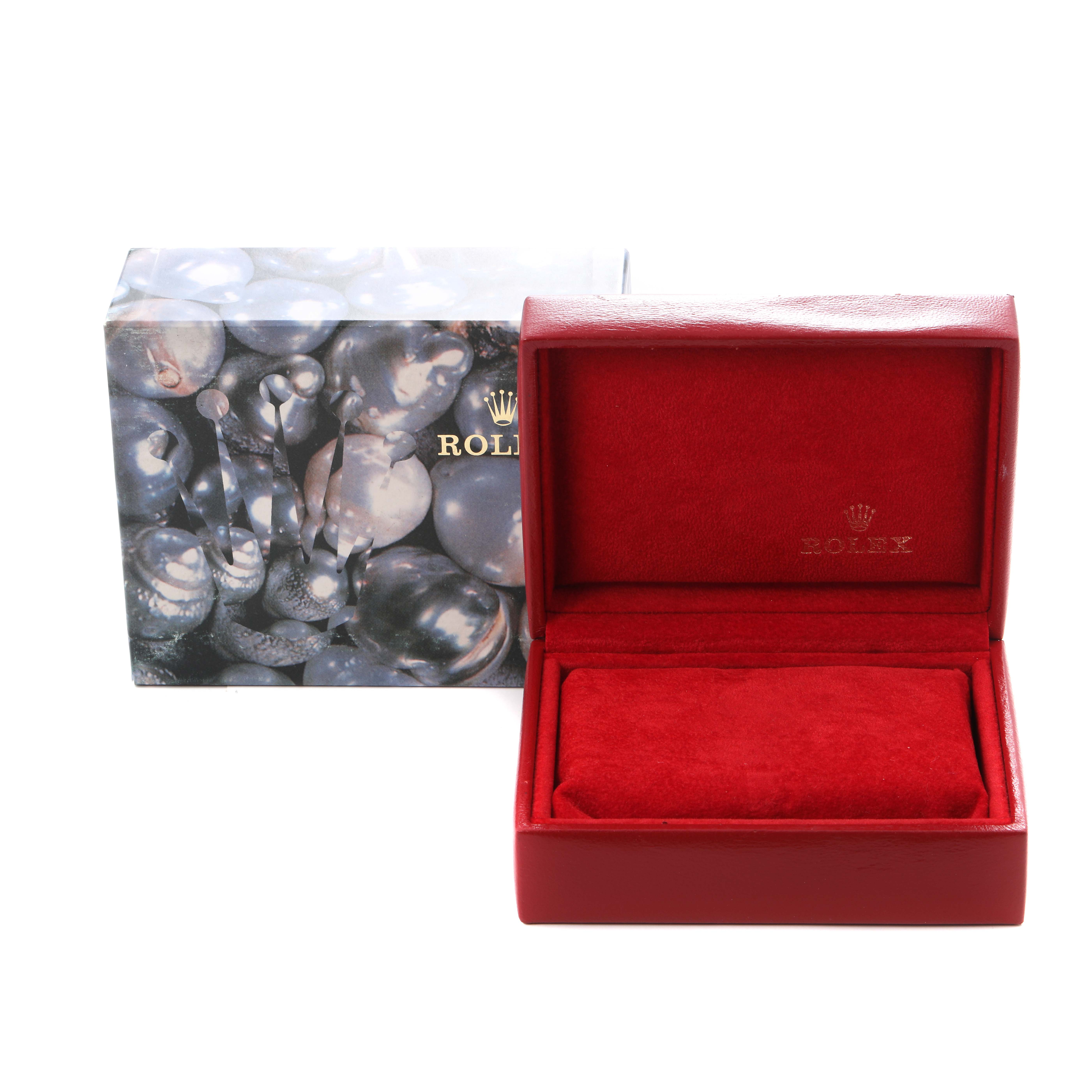 The image shows a Rolex Datejust 69173 Women
s Steel and Gold (two tone) White Dial 69173 Women
s Steel and Gold (two tone) White Dial watch box and packaging, with a red cushioned interior and designer outer box.