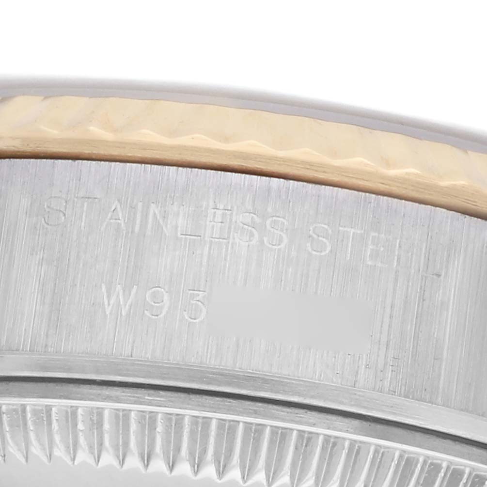 The image shows a close-up of the edge of a Rolex Datejust 69173 Women
s Steel and Gold (two tone) White Dial 69173 Women
s Steel and Gold (two tone) White Dial watch, highlighting the stainless steel part and bezel details.