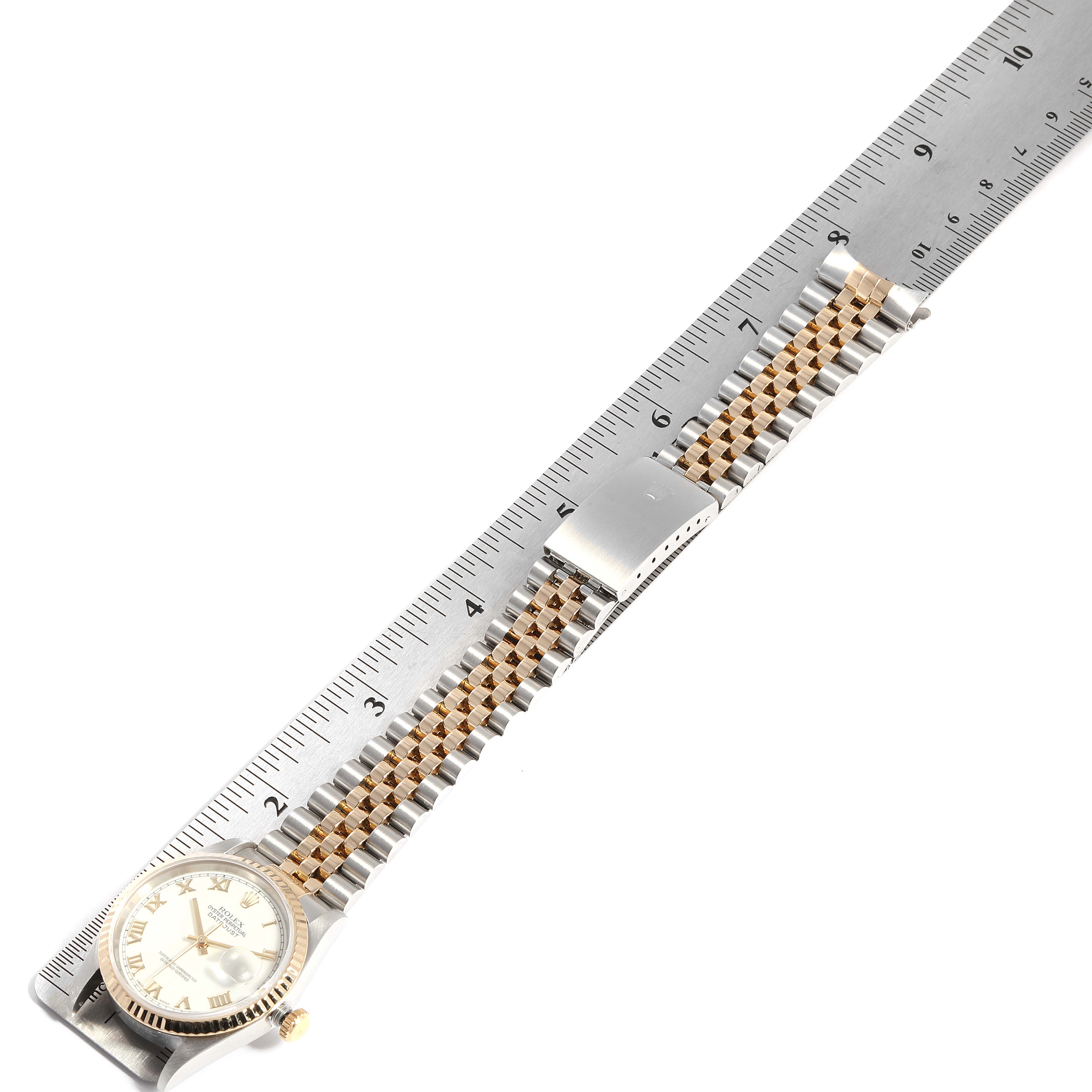 The image shows a Rolex Datejust 16233 Men
s Stainless Steel White Dial 16233 Men
s Stainless Steel White Dial watch laying flat, with its bracelet extended alongside a ruler for measurement.