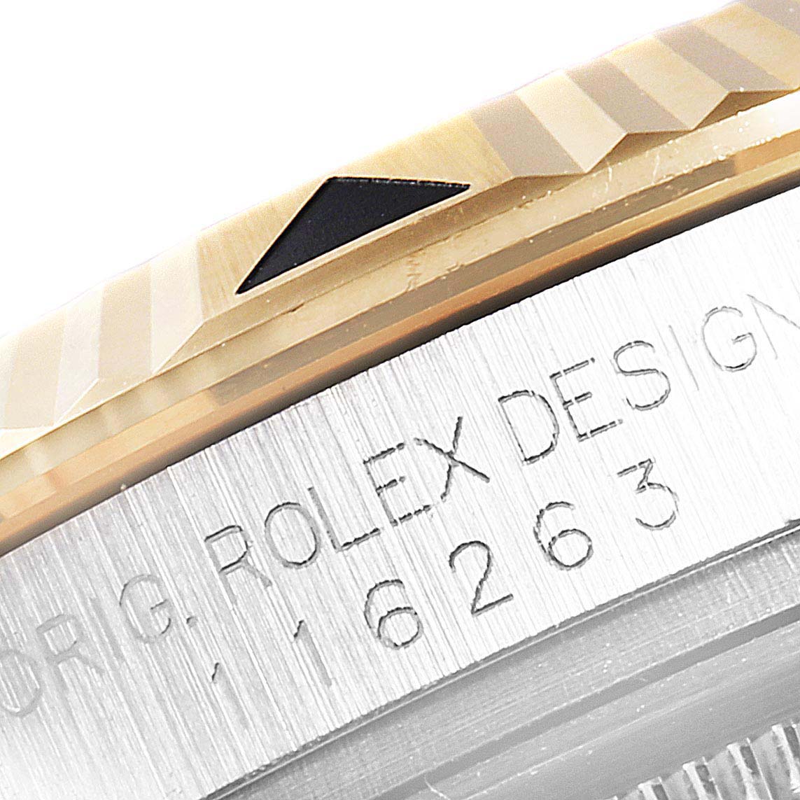 The image shows the side view of the Rolex Turn-o-Graph 116263 Men
s Steel and Gold (two tone) Champagne Dial 116263 Men
s Steel and Gold (two tone) Champagne Dial model, highlighting the bezel and part of the engraved casing.