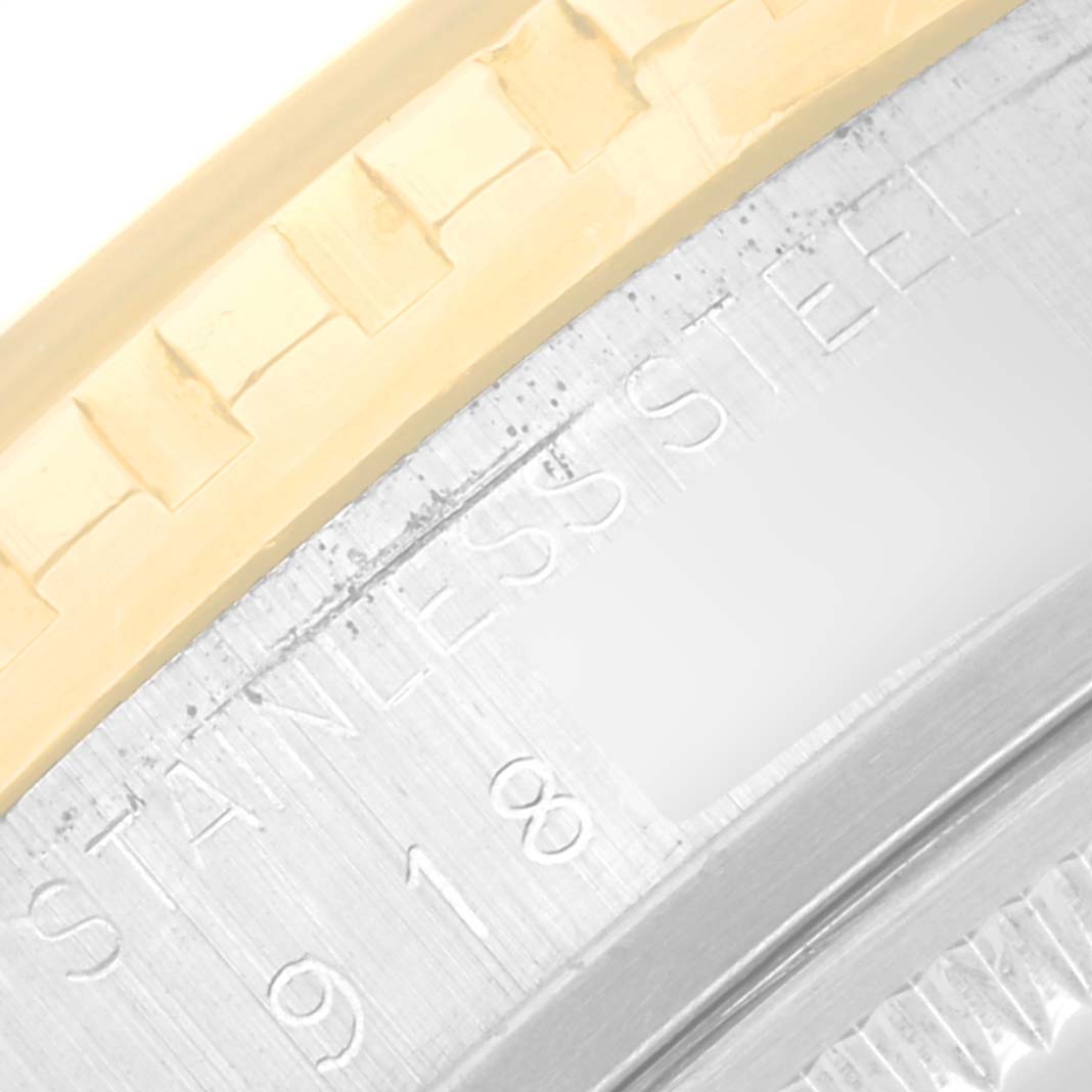 This close-up image of the Rolex Turn-o-Graph 16253 Men
s Steel and Gold (two tone) Silver Dial 16253 Men
s Steel and Gold (two tone) Silver Dial watch shows the fluted bezel and part of the stainless steel casing with engravings.