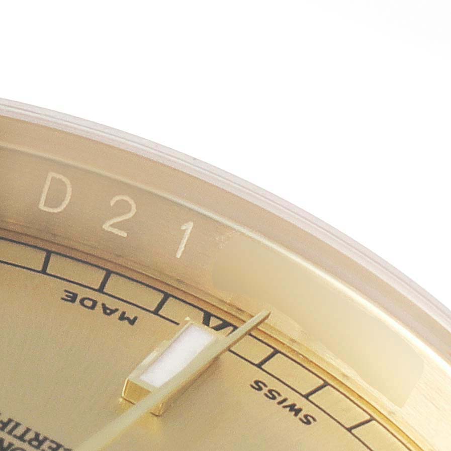 This image shows a close-up of the dial and hands of a Rolex President 116238 Men
s Yellow Gold Champagne Dial 116238 Men
s Yellow Gold Champagne Dial watch, focusing on part of the bezel and face markings.