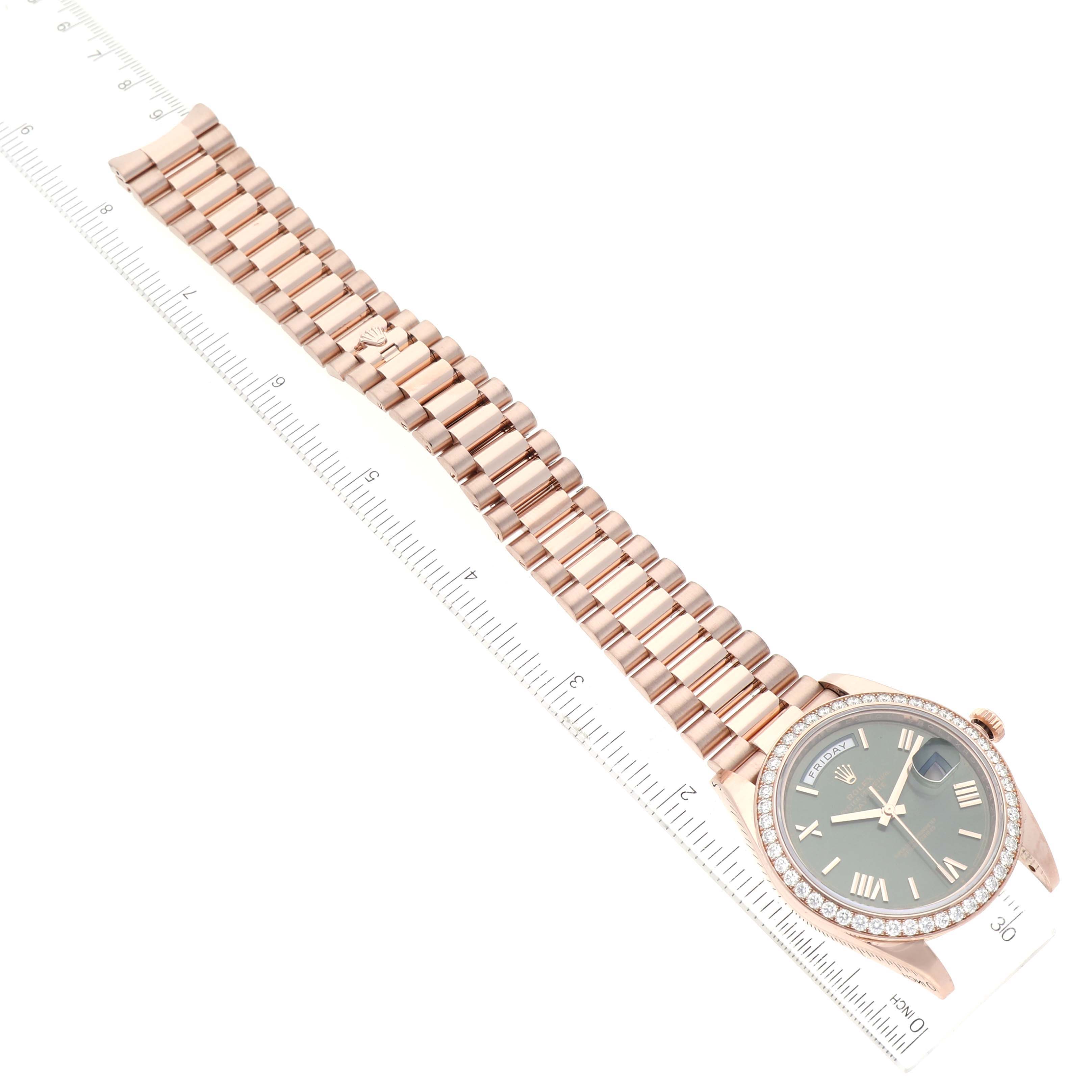 The image shows an aerial view of a Rolex President 228345 Men's Rose Gold Green Dial 228345 Men's Rose Gold Green Dial model watch, displaying its face and full bracelet on a ruler.