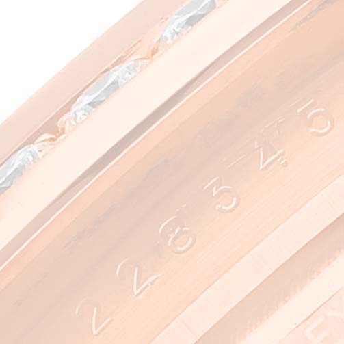 This close-up image shows the side engraving details on the Rolex President 228345 Men's Rose Gold Green Dial 228345 Men's Rose Gold Green Dial model watch bezel.