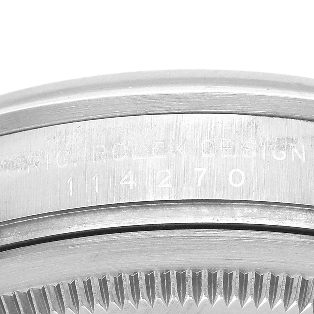 The image shows a close-up of the side of the Rolex Explorer 114270 Men
s Stainless Steel Black Dial 114270 Men
s Stainless Steel Black Dial watch case, displaying the model number "114270" with part of the bezel visible.