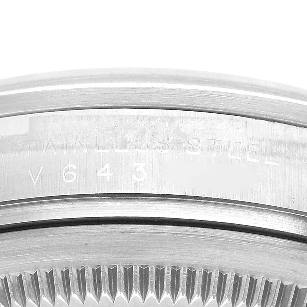 This image shows a close-up of the stainless steel case and bezel of a Rolex Explorer 114270 Men
s Stainless Steel Black Dial 114270 Men
s Stainless Steel Black Dial watch, focusing on serial numbers and details.