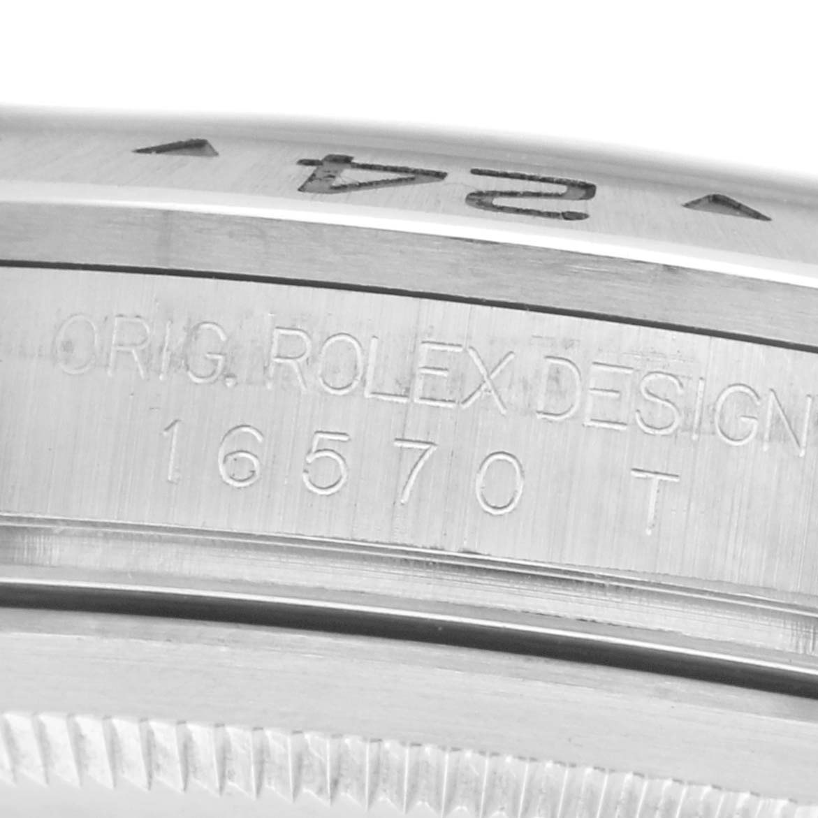 The image shows a close-up side view of a Rolex Explorer 16570 Men
s Stainless Steel White Dial 16570 Men
s Stainless Steel White Dial bezel with engraved design and model number "16570 T."