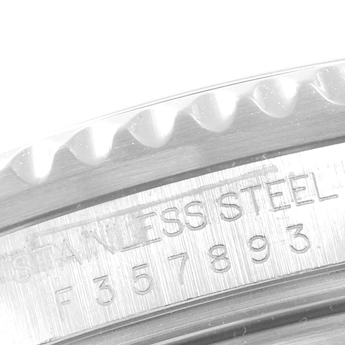 This image shows a close-up of the stainless steel bezel and serial or model number of a Rolex GMT-Master 16710 Men's Stainless Steel Black Dial 16710 Men's Stainless Steel Black Dial watch.