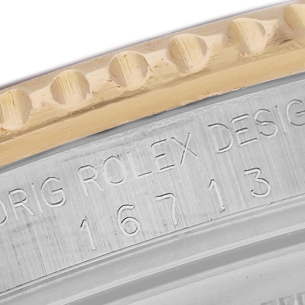 The image shows a close-up of a Rolex GMT-Master 16713 Men's Steel and Gold (two tone) Brown Dial 16713 Men's Steel and Gold (two tone) Brown Dial model, highlighting the edge of the bezel and engraved case details.