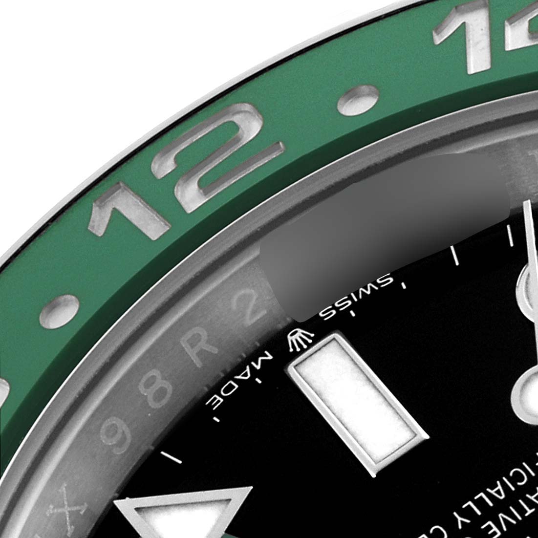 This close-up shows the bezel and part of the dial of a Rolex GMT-Master 126720VTNR-0001 Men
s Stainless Steel Black Dial 126720VTNR-0001 Men
s Stainless Steel Black Dial watch, highlighting the 12-hour marker.