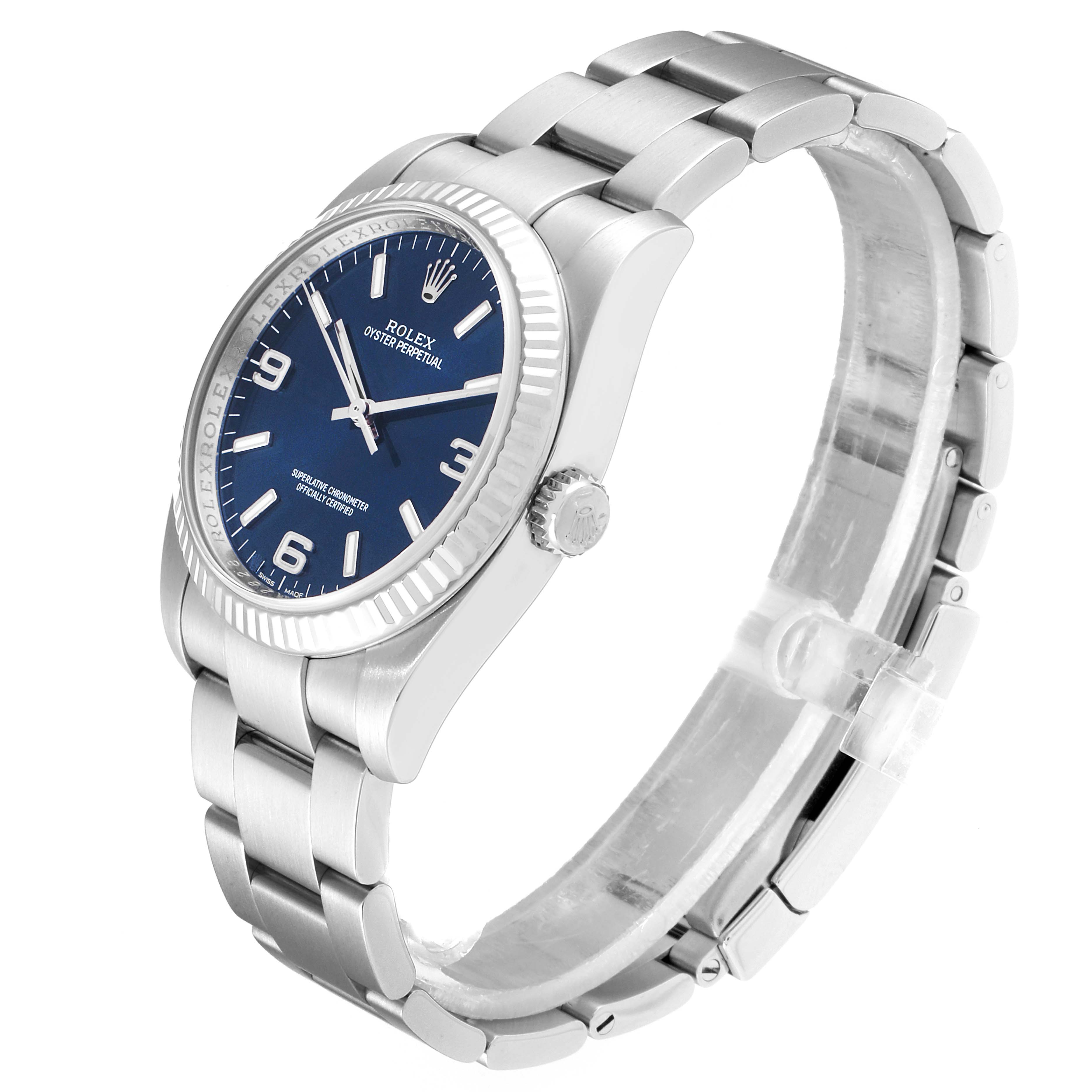 The image shows a Rolex Oyster Perpetual 116034 Men's Stainless Steel Blue Dial 116034 Men's Stainless Steel Blue Dial watch angled from the front-left, highlighting its blue dial, crown, and stainless steel bracelet.