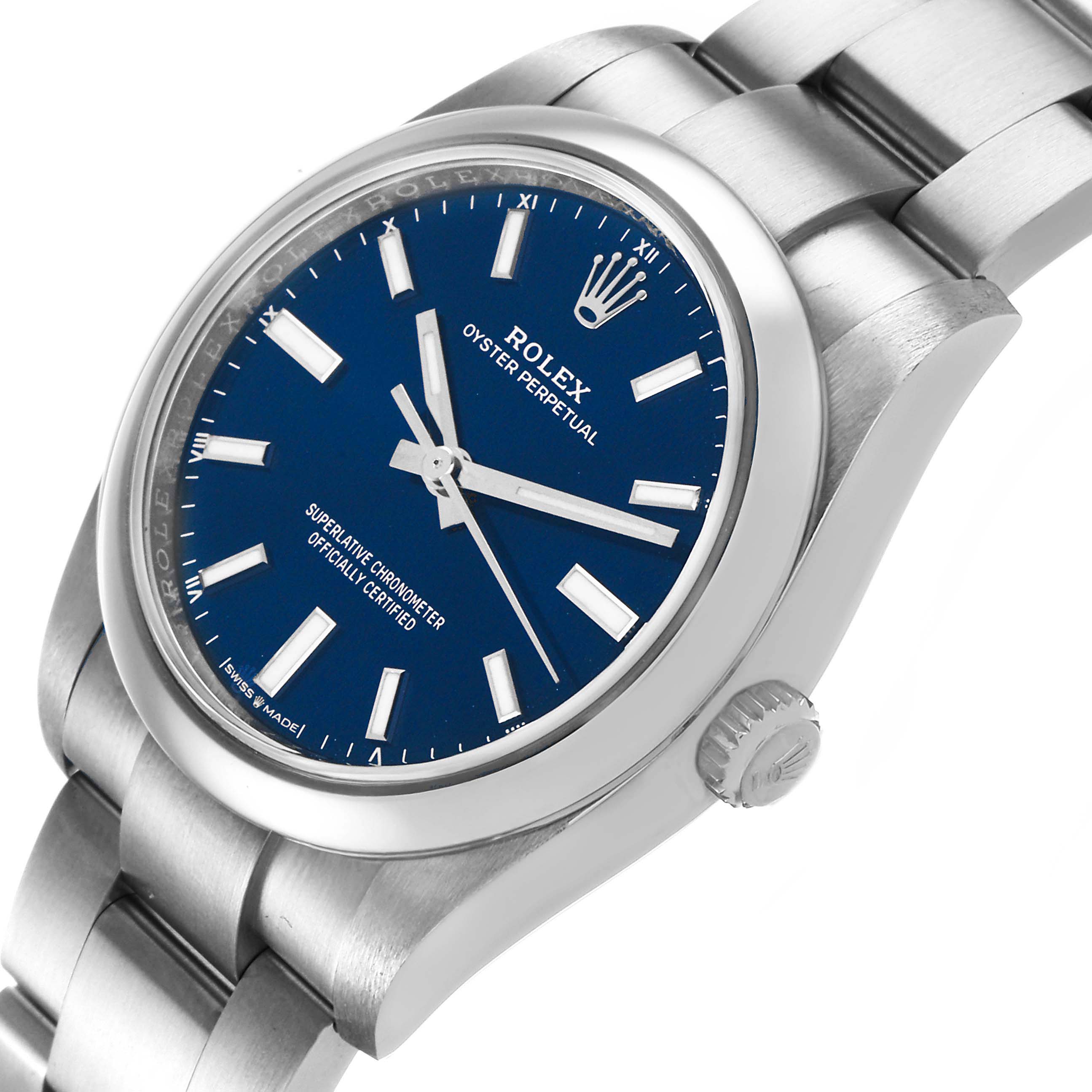 The Rolex Oyster Perpetual 124200 Men's Stainless Steel Blue Dial watch is shown from a slightly tilted side angle, highlighting the blue dial, crown, and bracelet.