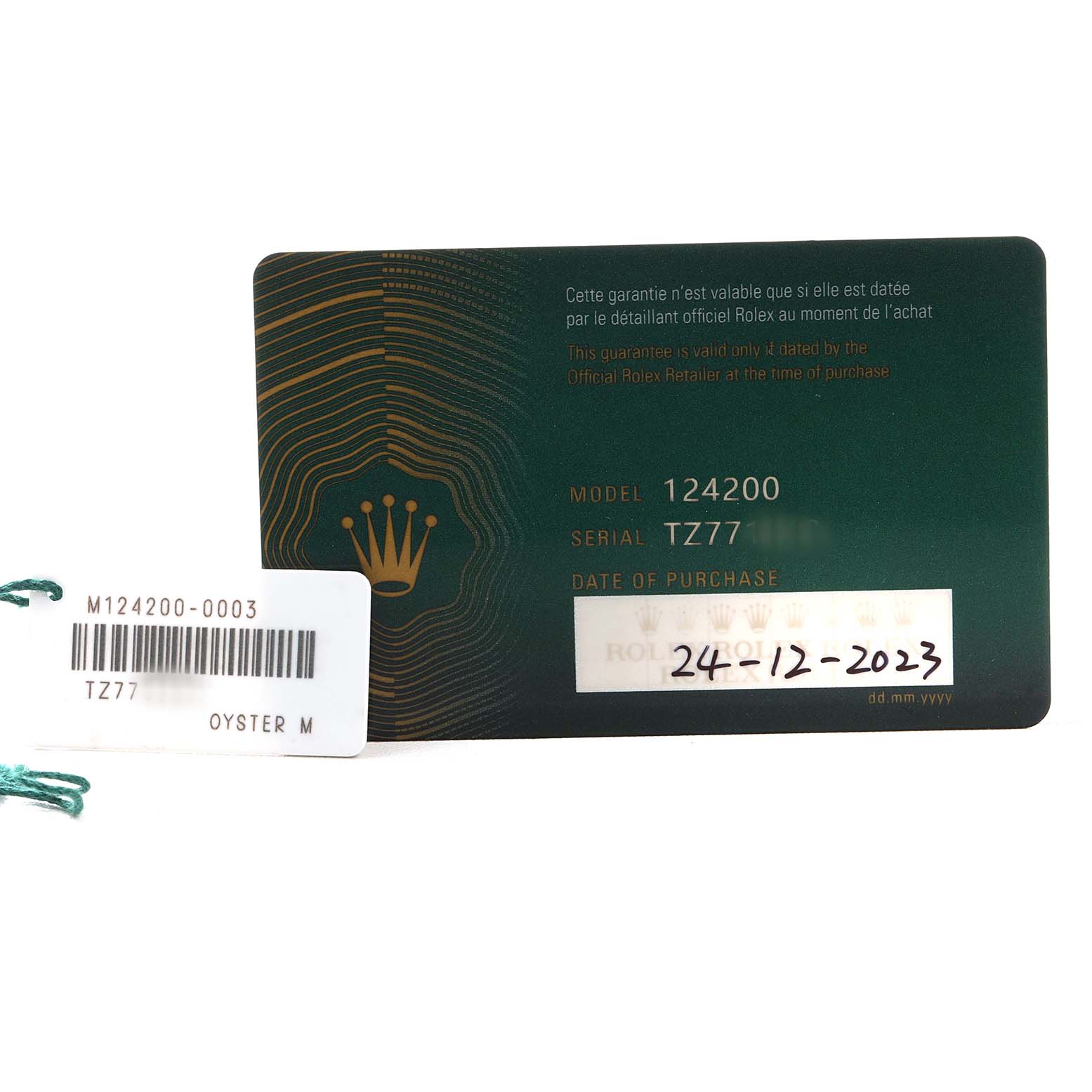 The image shows the warranty card and tag for the Rolex Oyster Perpetual 124200 Men's Stainless Steel Blue Dial model 124200, with serial number TZ77.