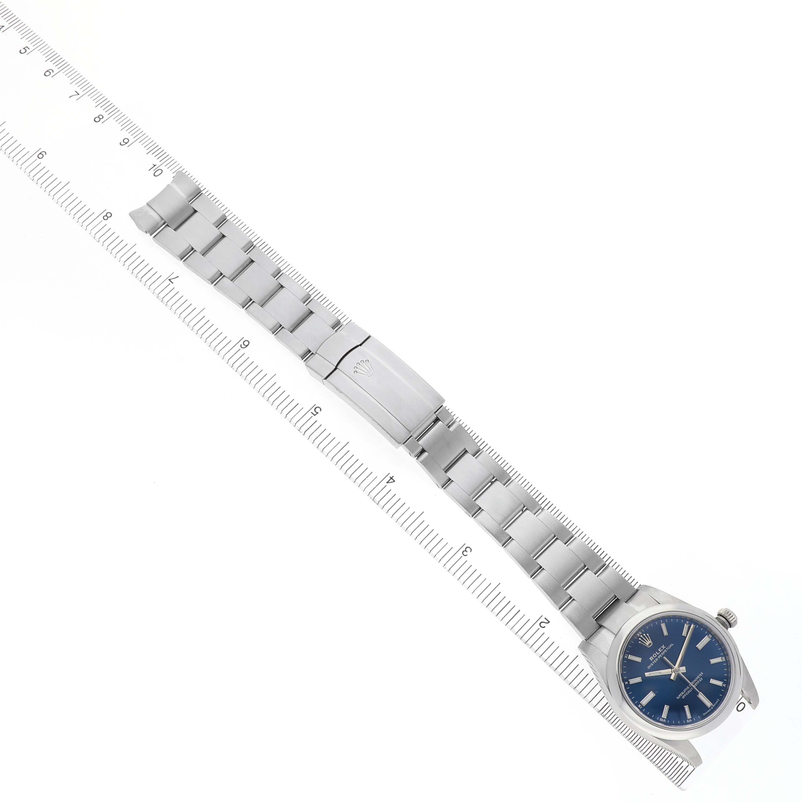 The Rolex Oyster Perpetual 124200 Men's Stainless Steel Blue Dial watch is shown from a top-down angle, displaying the full bracelet and blue dial face.