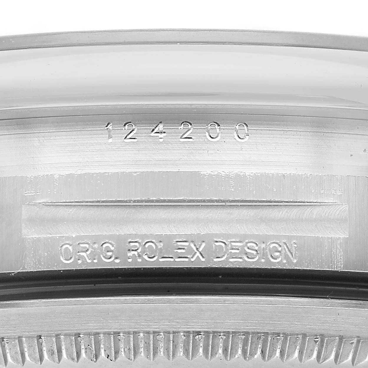 The image shows a close-up of the side of a Rolex Oyster Perpetual 124200 Men's Stainless Steel Blue Dial watch, highlighting the model number and "ORIG. ROLEX DESIGN" engraving.