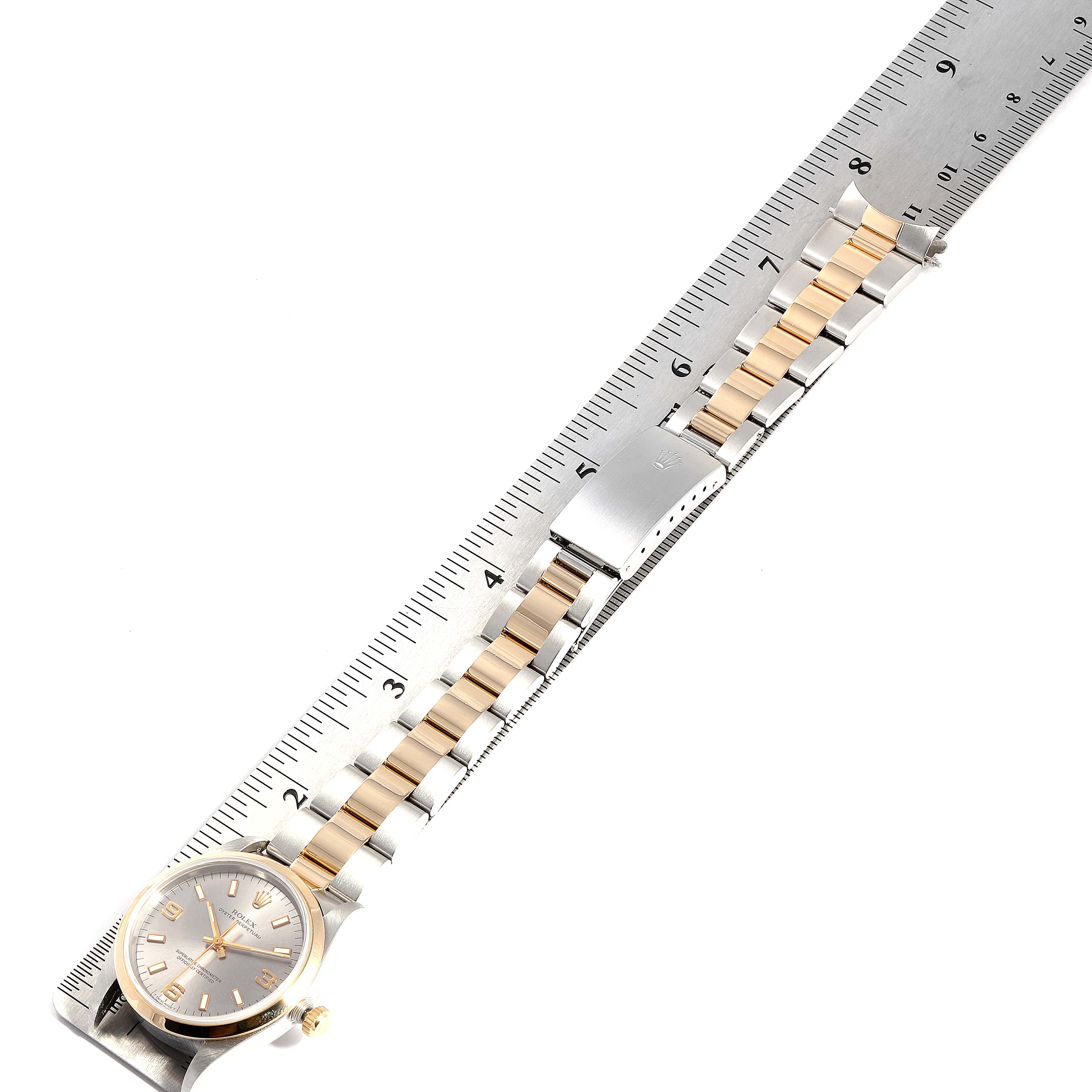 The image shows a Rolex Oyster Perpetual 14203 Men's Steel and Gold (two tone) Grey Dial 14203 Men's Steel and Gold (two tone) Grey Dial watch laid flat with a two-tone bracelet alongside a ruler for measurement.