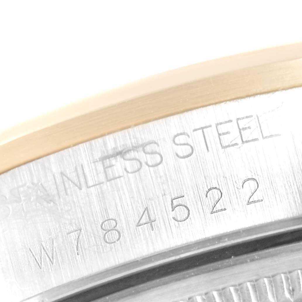 This image shows a close-up of the case back engraving on a Rolex Oyster Perpetual 14203 Men's Steel and Gold (two tone) Grey Dial 14203 Men's Steel and Gold (two tone) Grey Dial watch.
