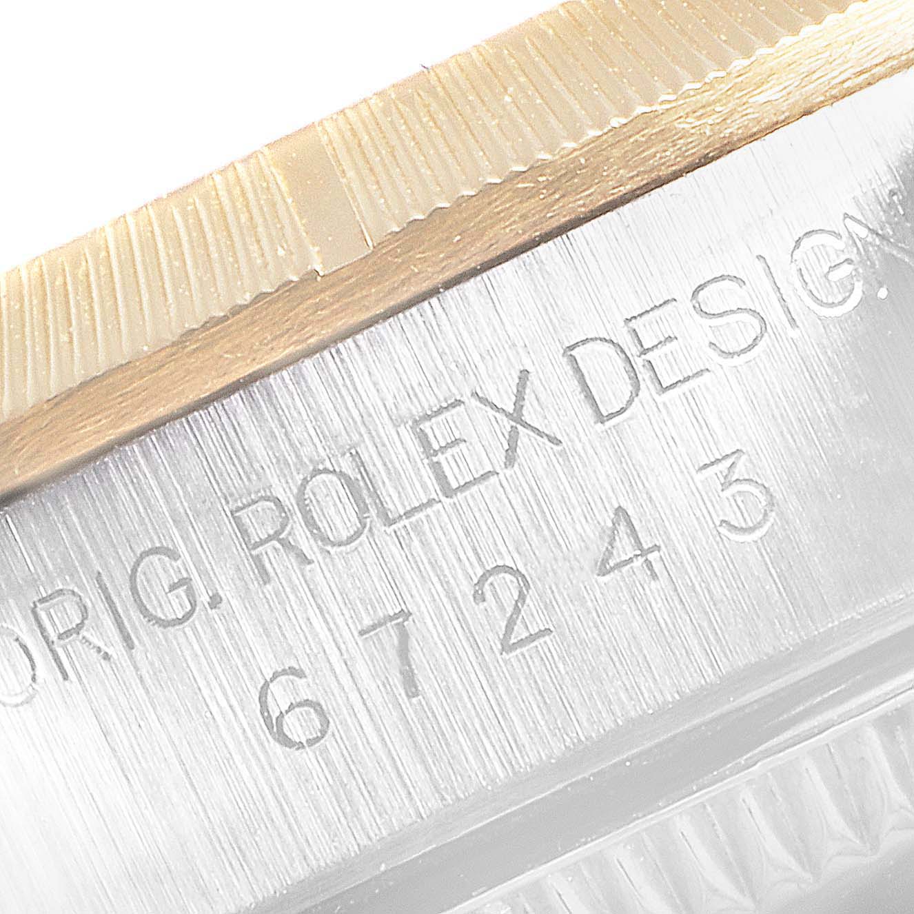 This image shows the case side with engraving details, including the model number, of a Rolex Oyster Perpetual 67243 Women's Steel and Gold (two tone) White Dial 67243 Women's Steel and Gold (two tone) White Dial watch.