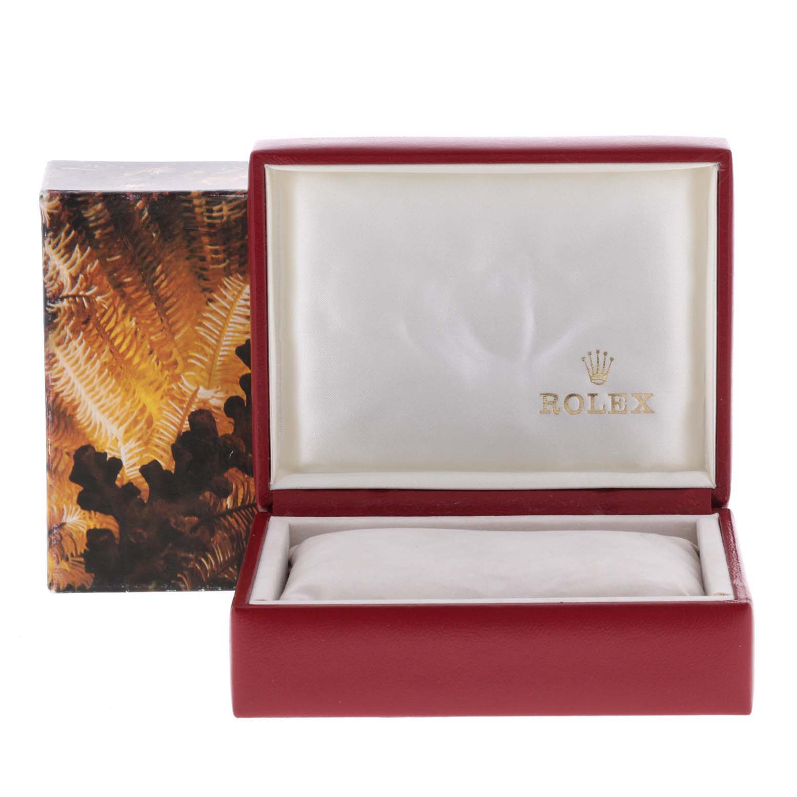 This image shows an open Rolex President 69178 Women's Yellow Gold Black Dial 69178 Women's Yellow Gold Black Dial model watch box, with a red exterior and a padded white interior.