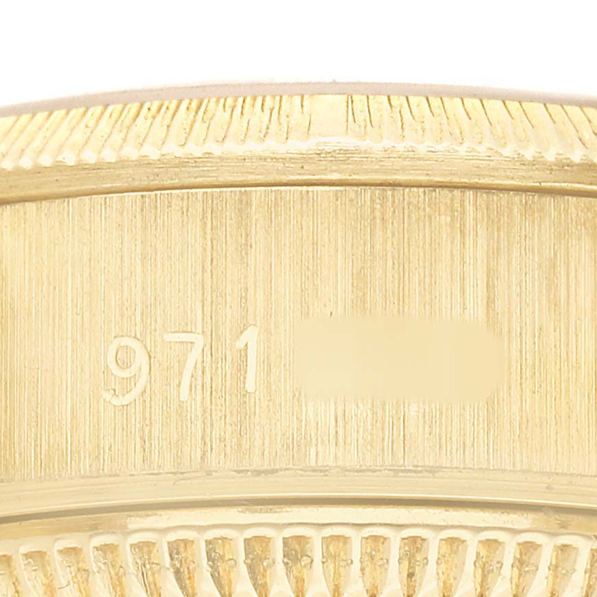 The image shows a close-up of the engraved edge of a Rolex President 69278 Women's Yellow Gold Champagne Dial model watch.