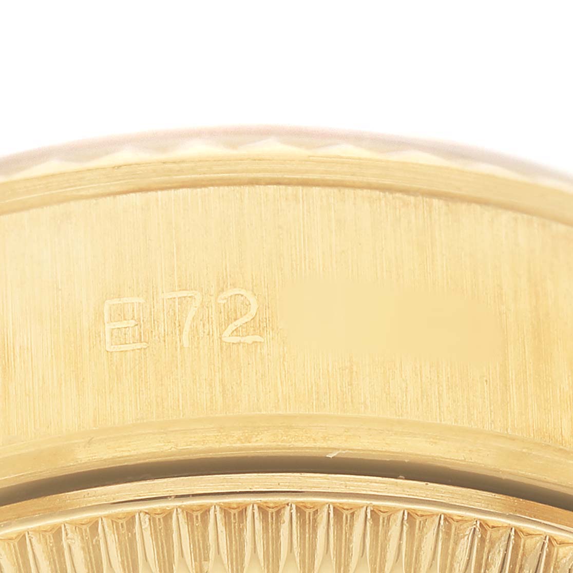 The image shows the side of a Rolex President 69178 Womens Yellow Gold Yellow Dial watch case, highlighting its serial number engraving and fluted bezel.