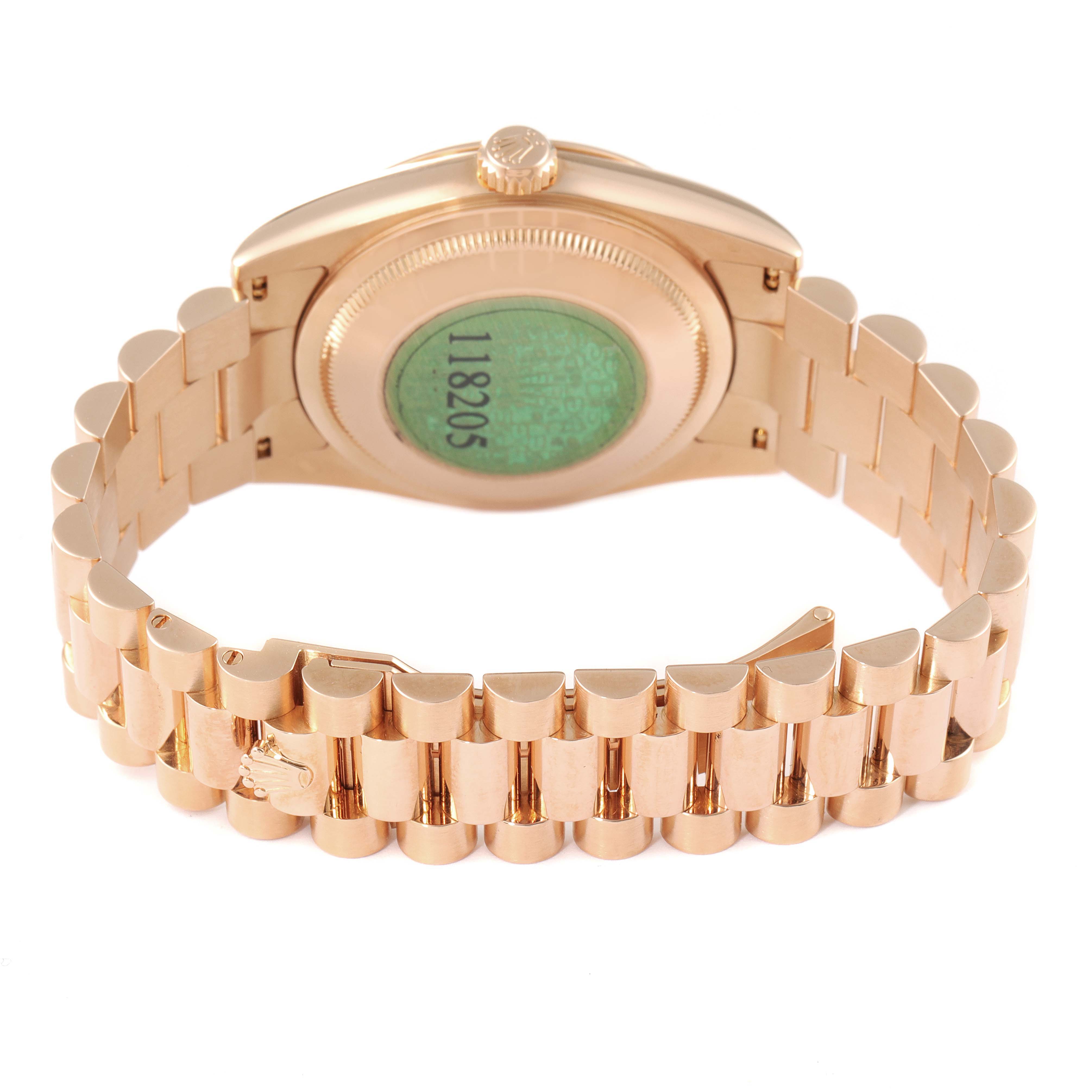 The image shows the back view of a Rolex President 118205 Men's Rose Gold Silver Dial 118205 Men's Rose Gold Silver Dial model watch, highlighting the green case back sticker and the gold bracelet.