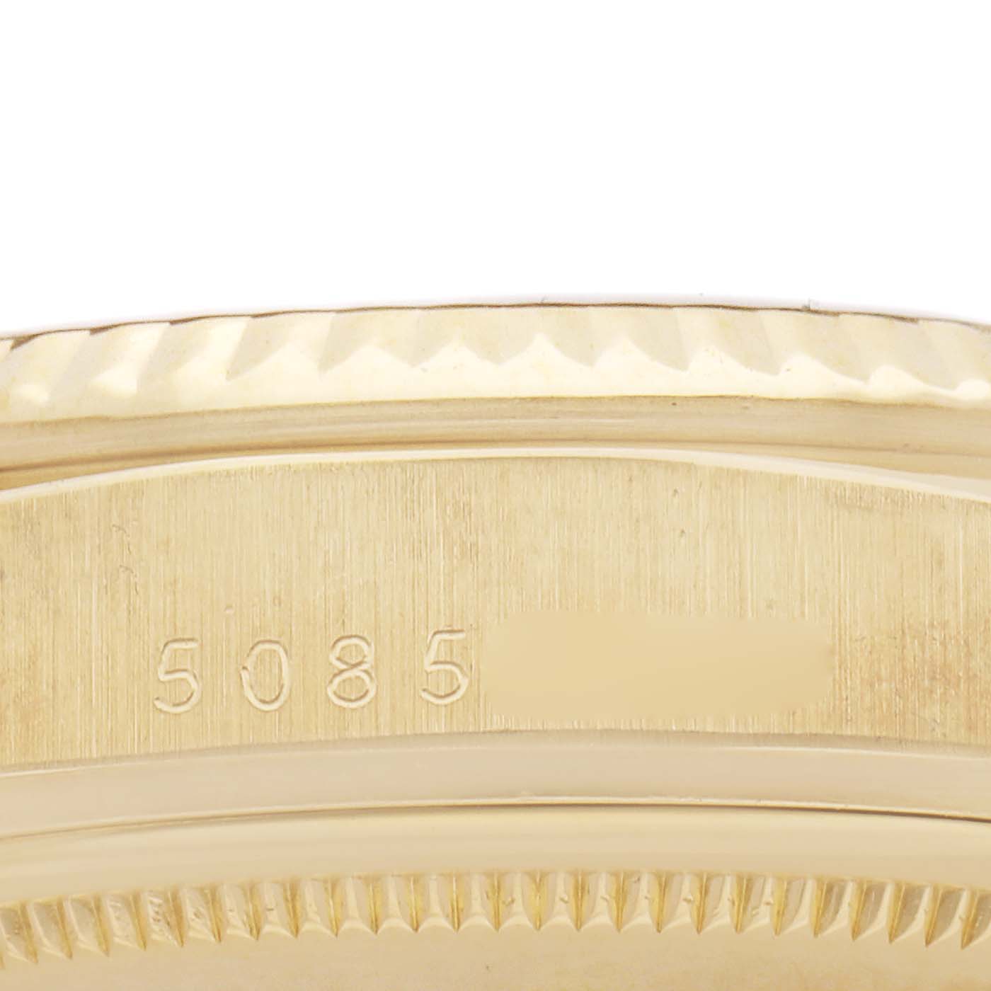 The image shows a close-up of the side of a Rolex President 1803 Men
s Yellow Gold Champagne Dial 1803 Men
s Yellow Gold Champagne Dial watch case, highlighting the serial number engraving.