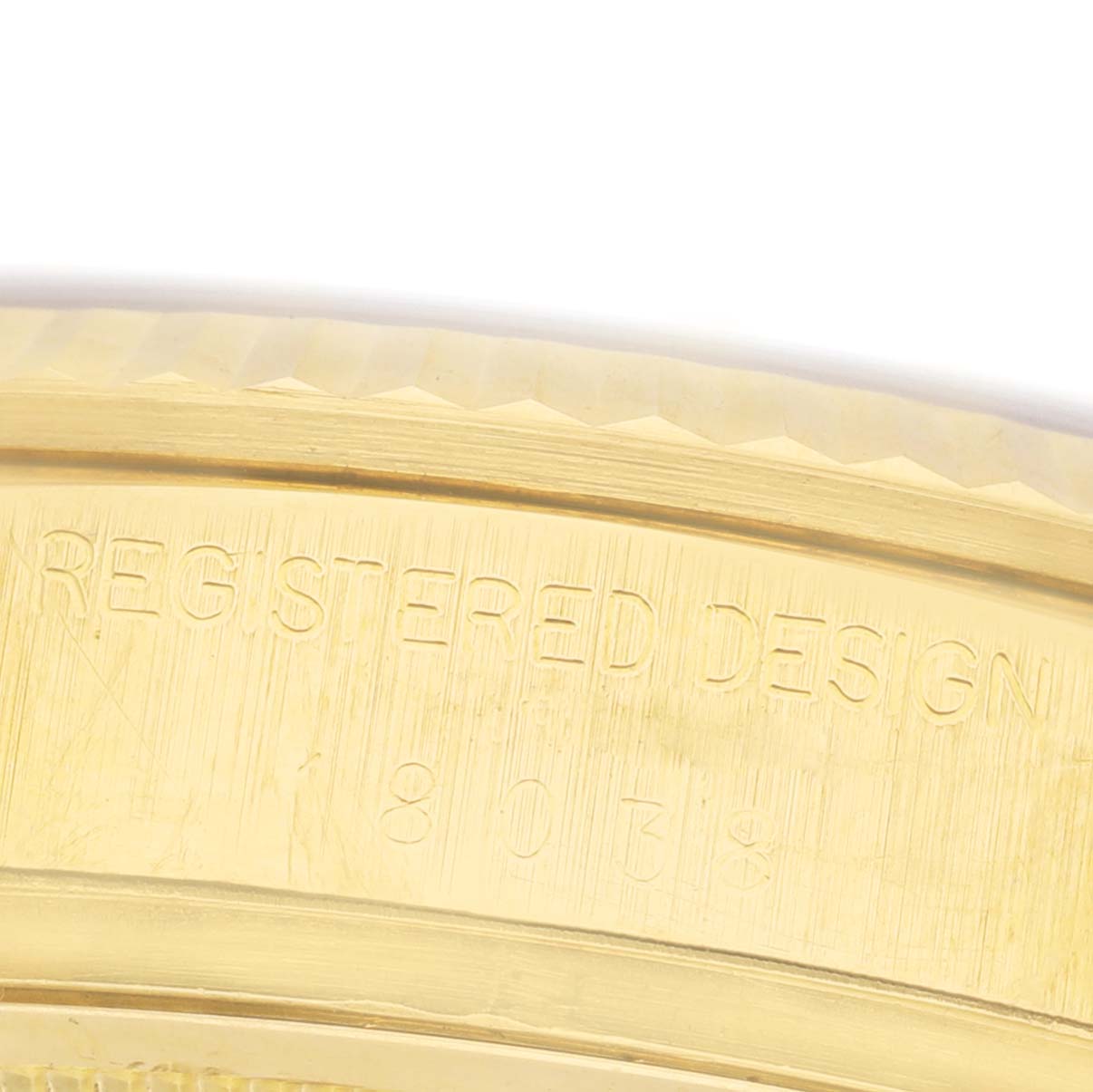The image shows a close-up of the edge and inner inscription of a Rolex President 18038 Men's Yellow Gold Champagne Dial watch case back.