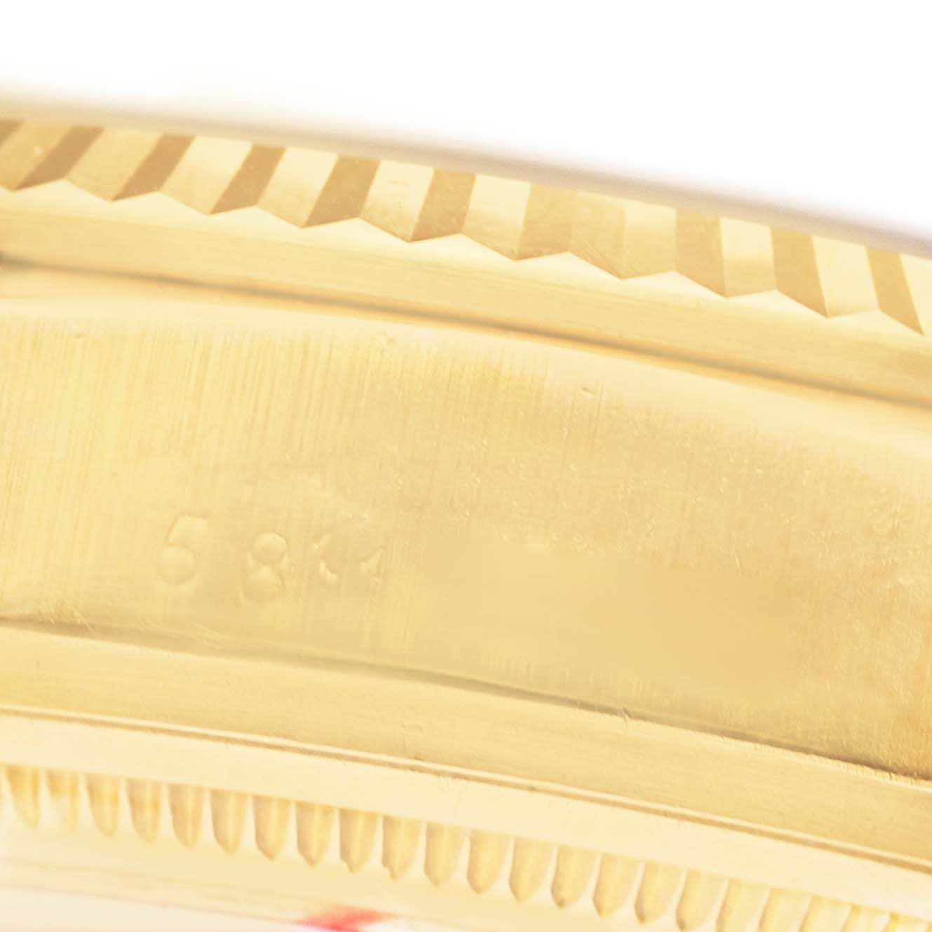 The image shows a close-up of the bezel and side of the case of a Rolex President 18038 Men's Yellow Gold Champagne Dial watch.