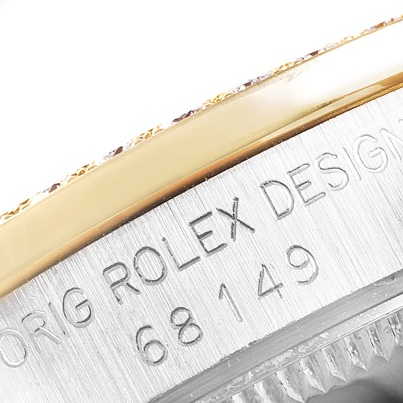 This close-up image shows the side engraving of a Rolex President 68149 Women's Yellow Gold Brown Dial 68149 Women's Yellow Gold Brown Dial model watch.