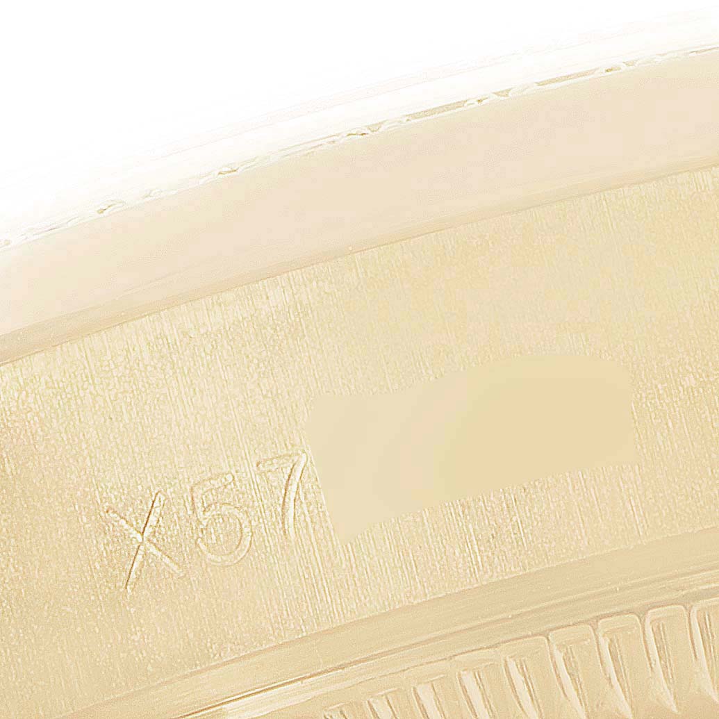 This image shows a close-up angle of the inner bezel engraving of a Rolex President 69158 Women's Yellow Gold Grey Dial 69158 Women's Yellow Gold Grey Dial model watch.