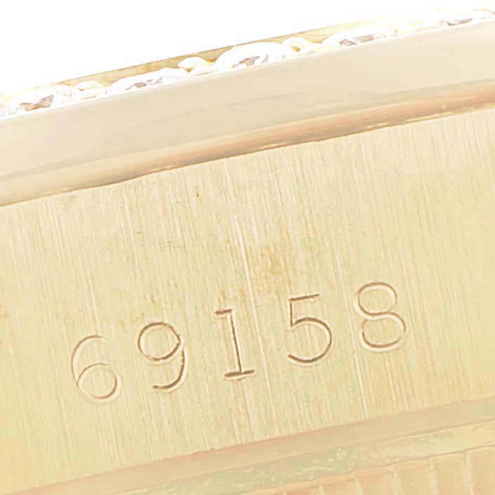This is a close-up of the serial number engraved on the side of a Rolex President 69158 Women's Yellow Gold Grey Dial 69158 Women's Yellow Gold Grey Dial model watch.