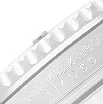 This image shows a close-up of the side of a Rolex Submariner 114060 Men's Stainless Steel Black Dial 114060 Men's Stainless Steel Black Dial watch case, highlighting the engraved model number and the serrated bezel edge.