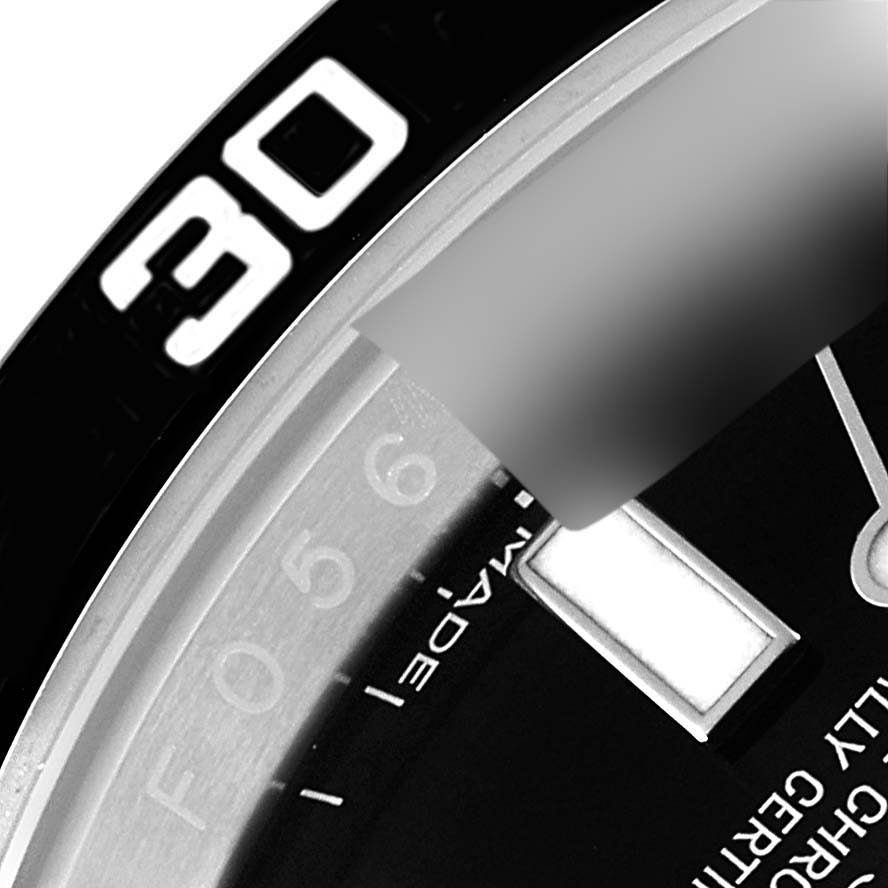 This image shows a close-up of the bezel and part of the dial of the Rolex Submariner 114060 Men's Stainless Steel Black Dial 114060 Men's Stainless Steel Black Dial watch.