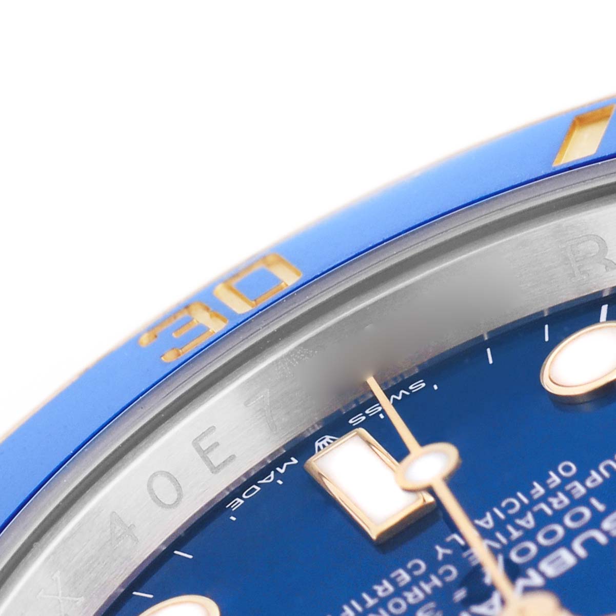 The image shows a close-up of the blue dial and bezel of a Rolex Submariner 126613LB Men's Steel and Gold (two tone) Blue Dial, highlighting the indices and minute markers.