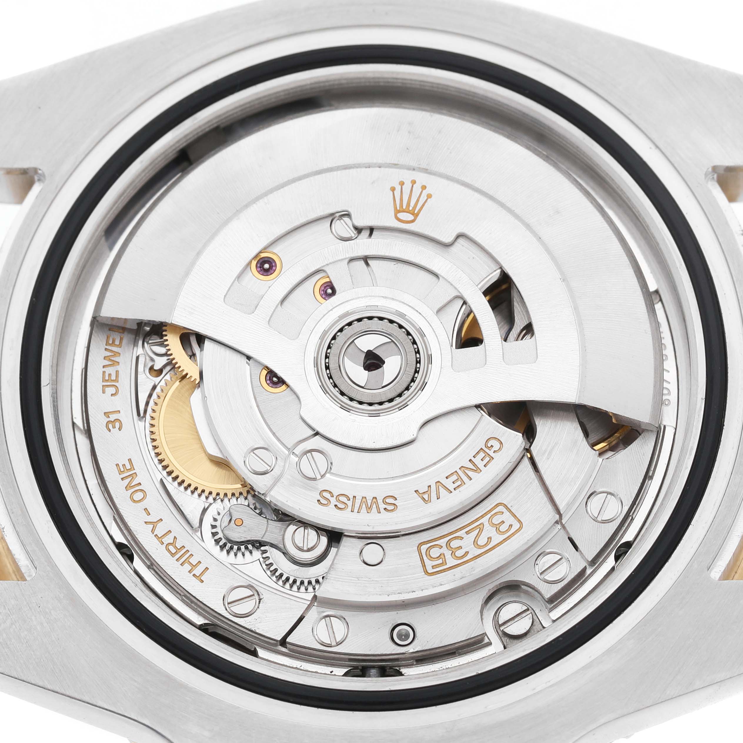 The image shows the movement of a Rolex Submariner 126613LB Men's Steel and Gold (two tone) Blue Dial, viewed from the back, highlighting intricate gears and mechanisms.