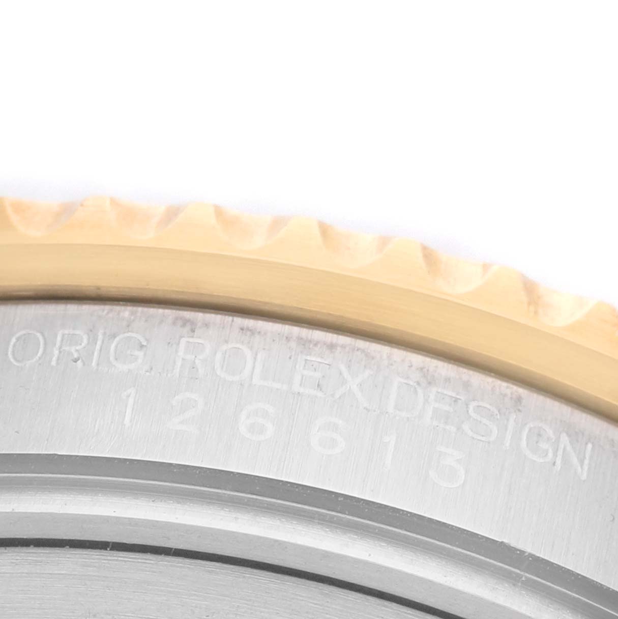 The image shows a close-up of the edge and bezel of the Rolex Submariner 126613LB Men's Steel and Gold (two tone) Blue Dial, highlighting the engraved details.