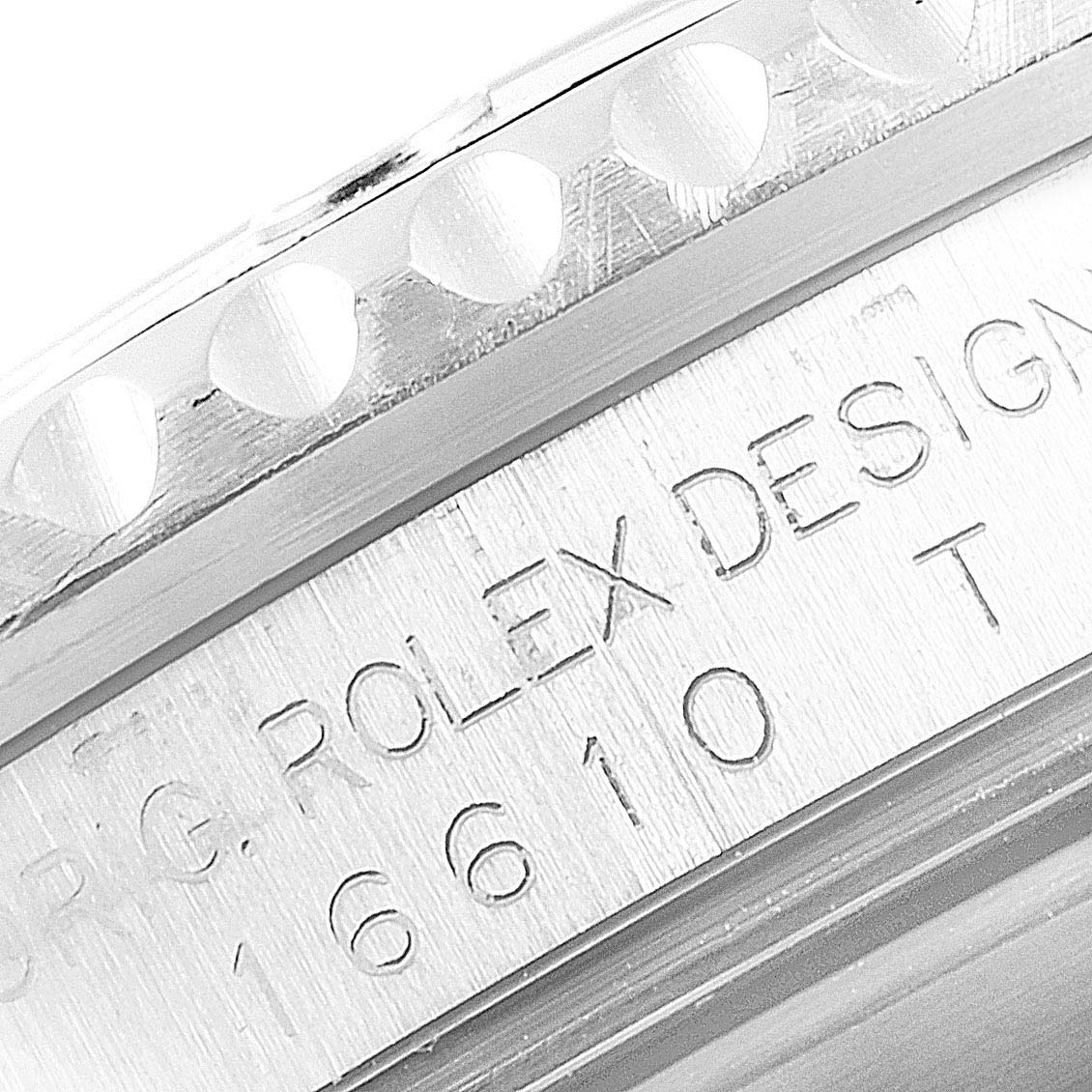 The image captures a macro view of the serial number engraving on the side of the Rolex Submariner 16610 Men
s Stainless Steel Black Dial 16610 Men
s Stainless Steel Black Dial watch case.