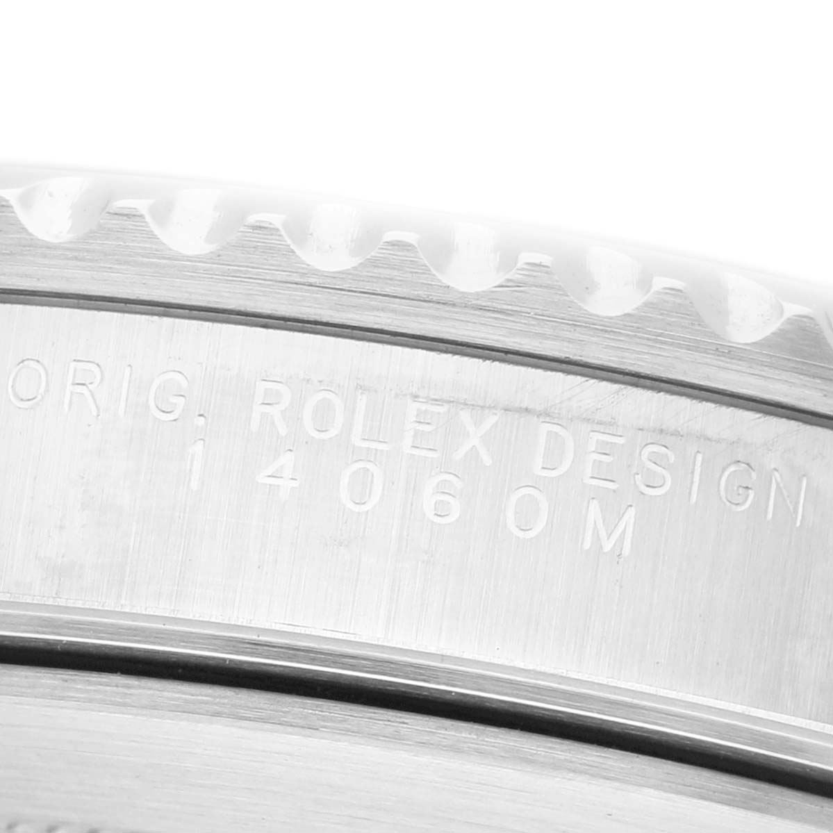 The image shows a close-up of the side of a Rolex Submariner 14060M Mens Stainless Steel Black Dial, focusing on the engraved serial and model numbers.